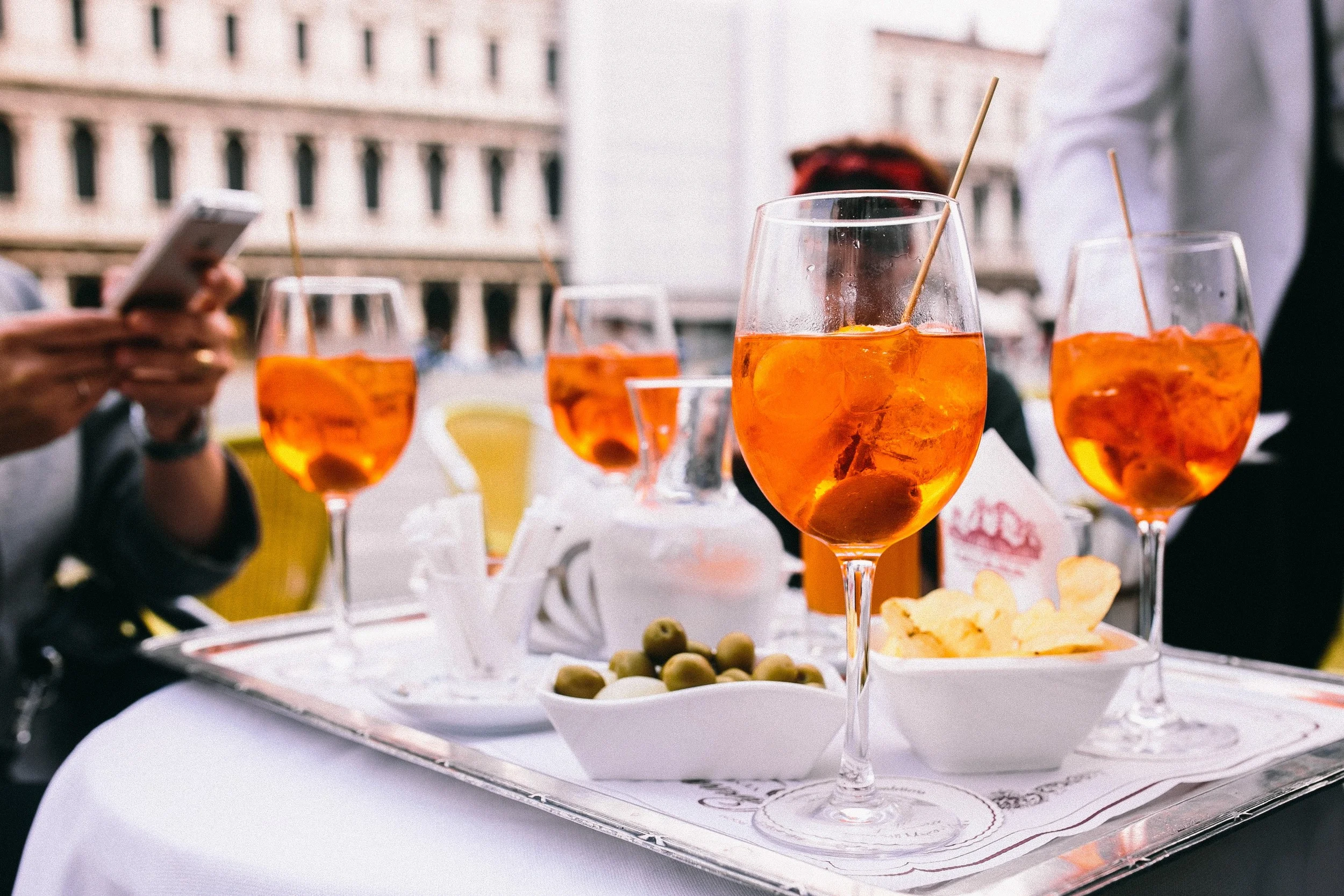 kaboompics.com_Glass of aperol spritz cocktail with olive and orange piece (1).jpg