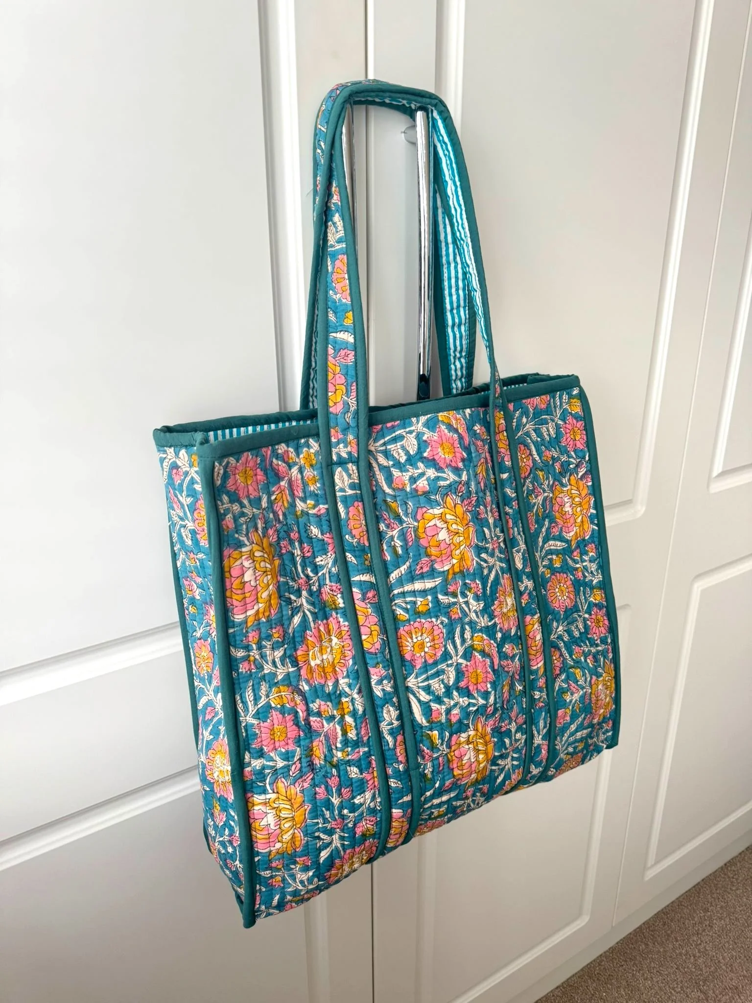 Colourful beach tote bag with floral print, contrasting trim and striped lining