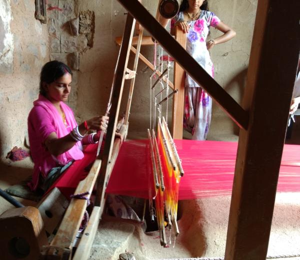 Woman weaving on a pitloom.gif