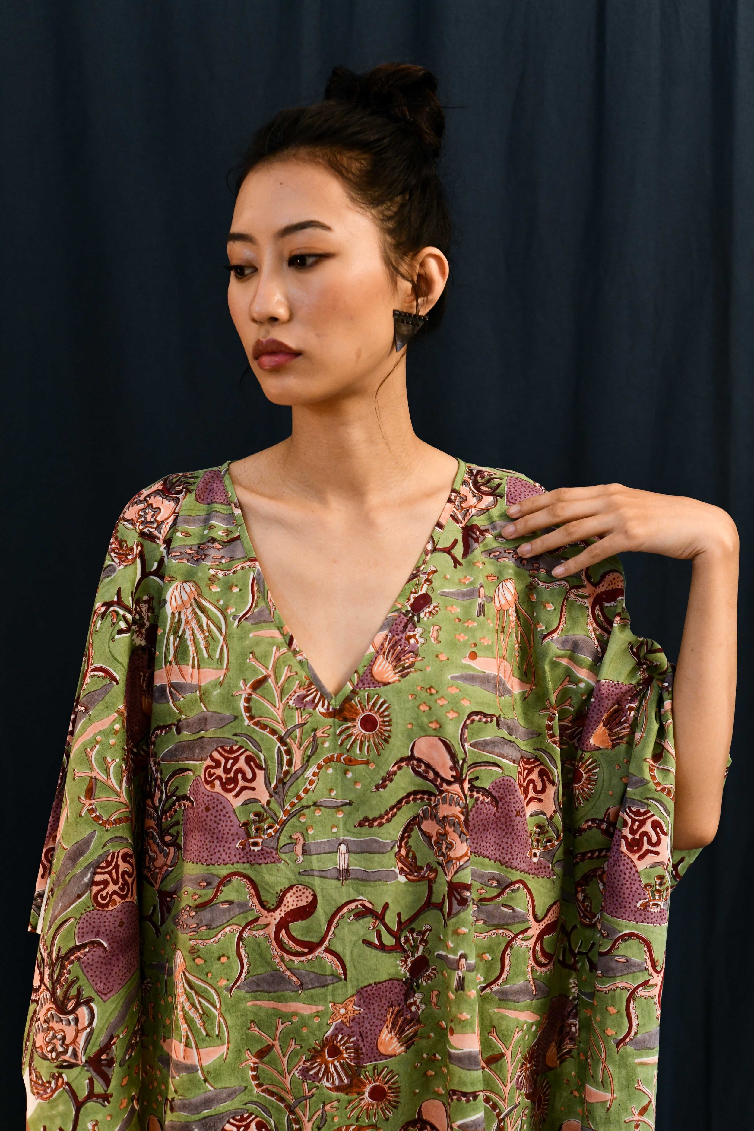 Close up of south asian female wearing a sea green nautical block print summer kaftan maxi dress