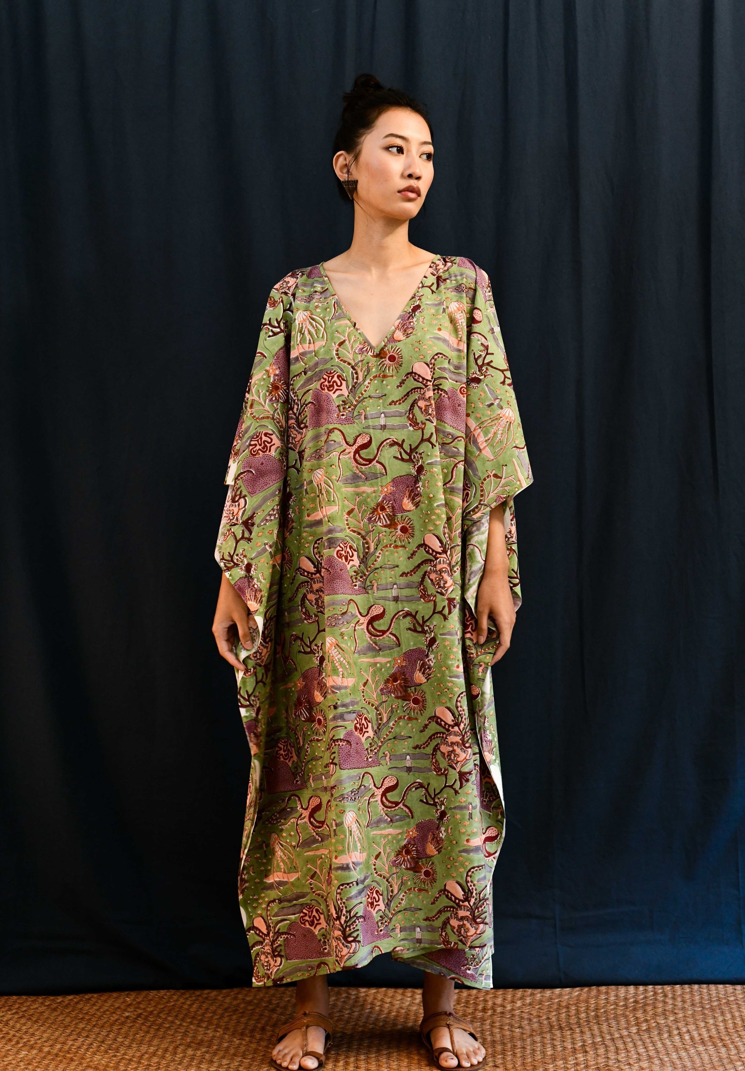 Asian female wearing a sea green v- neck block print cotton kaftan dress