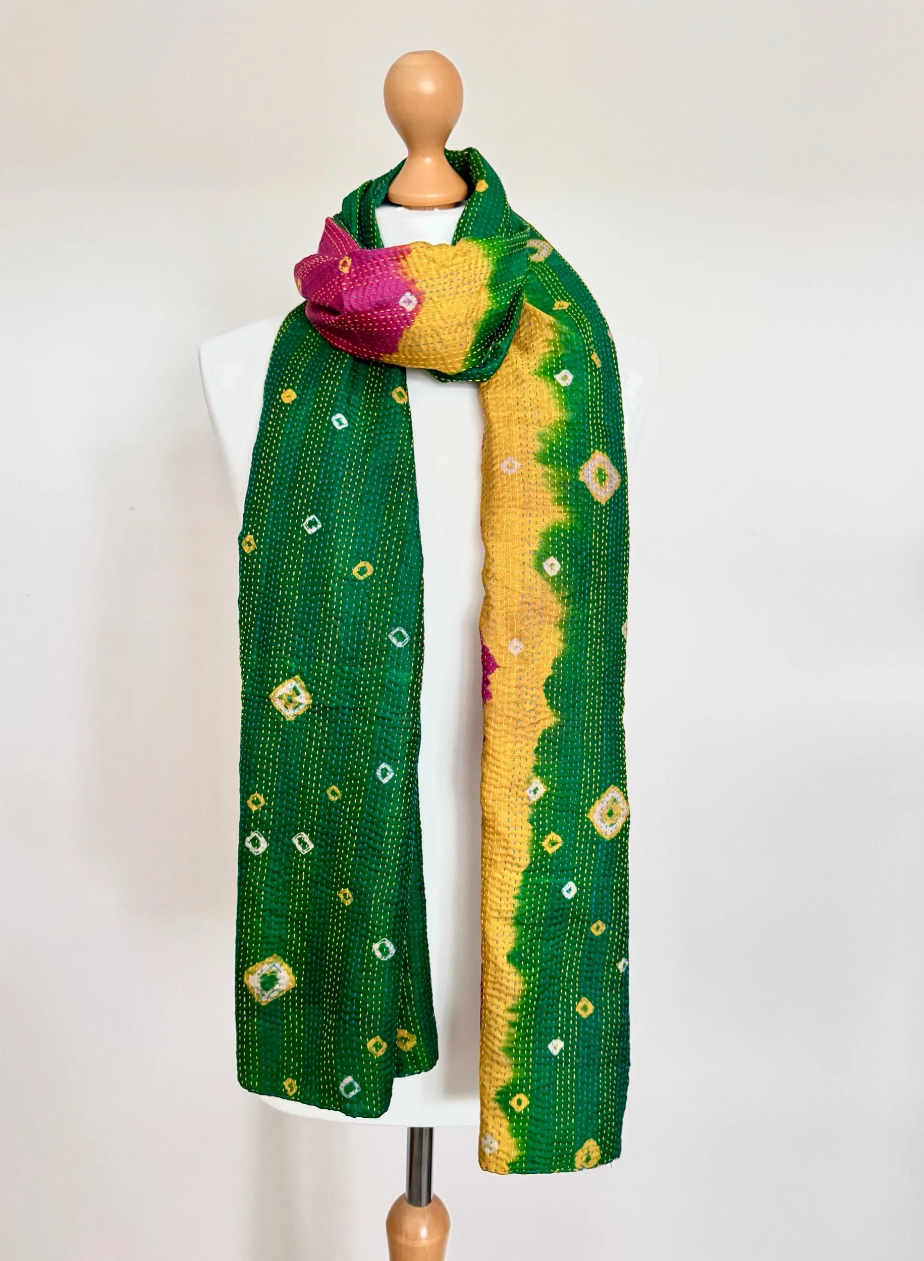 A multi-coloured upcycled sari silk scarf handmade in India by artisans using vintage sari silk hand embroidered with Kantha stitch.