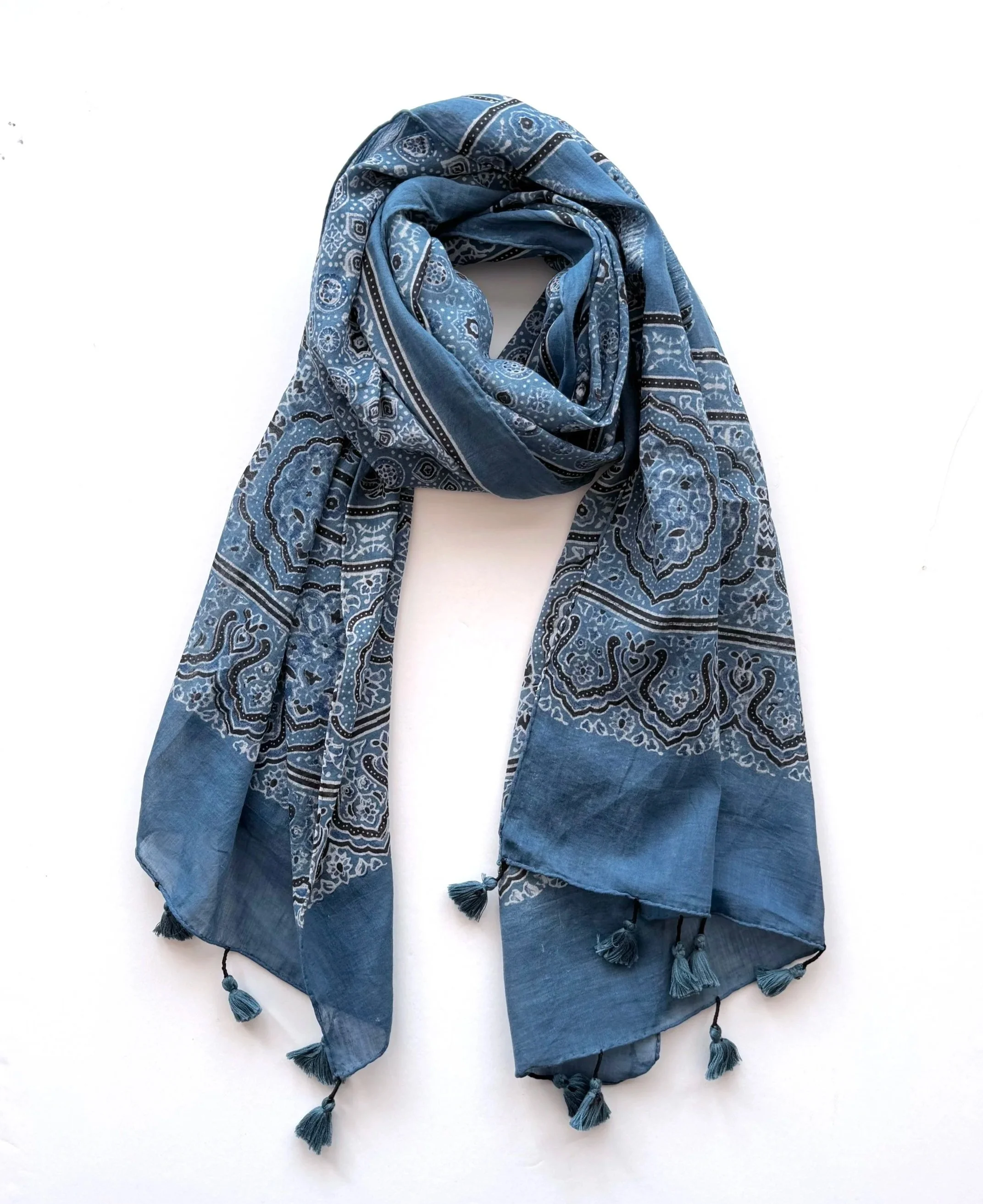 Indigo blue Ajrakh handblock printed cotton scarf with tassels, styled on a white background