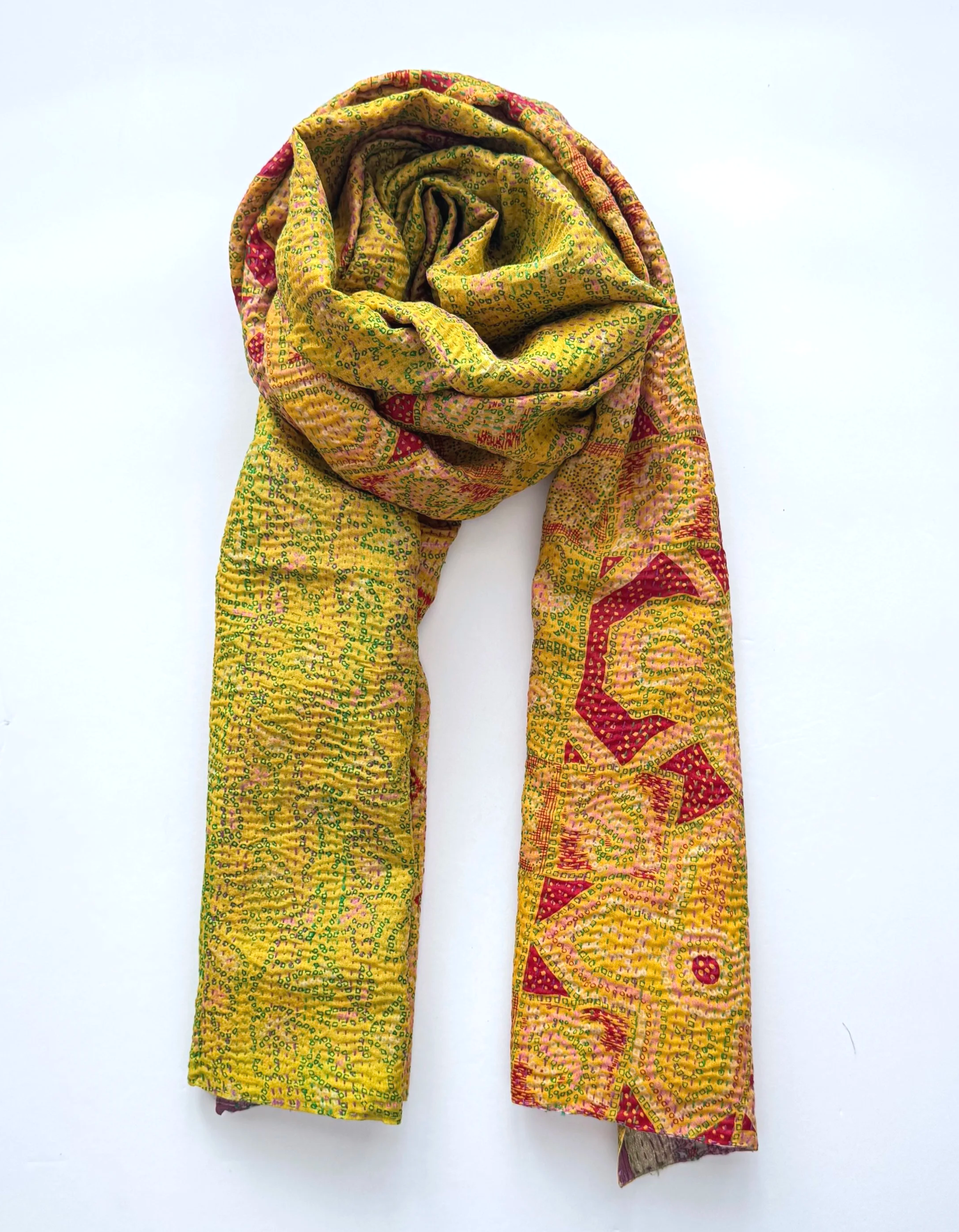 A one-of-a-kind pink and yellow kantha sari scarf crafted from recycled sari silk and hand embroidered all over with kantha running stitch.