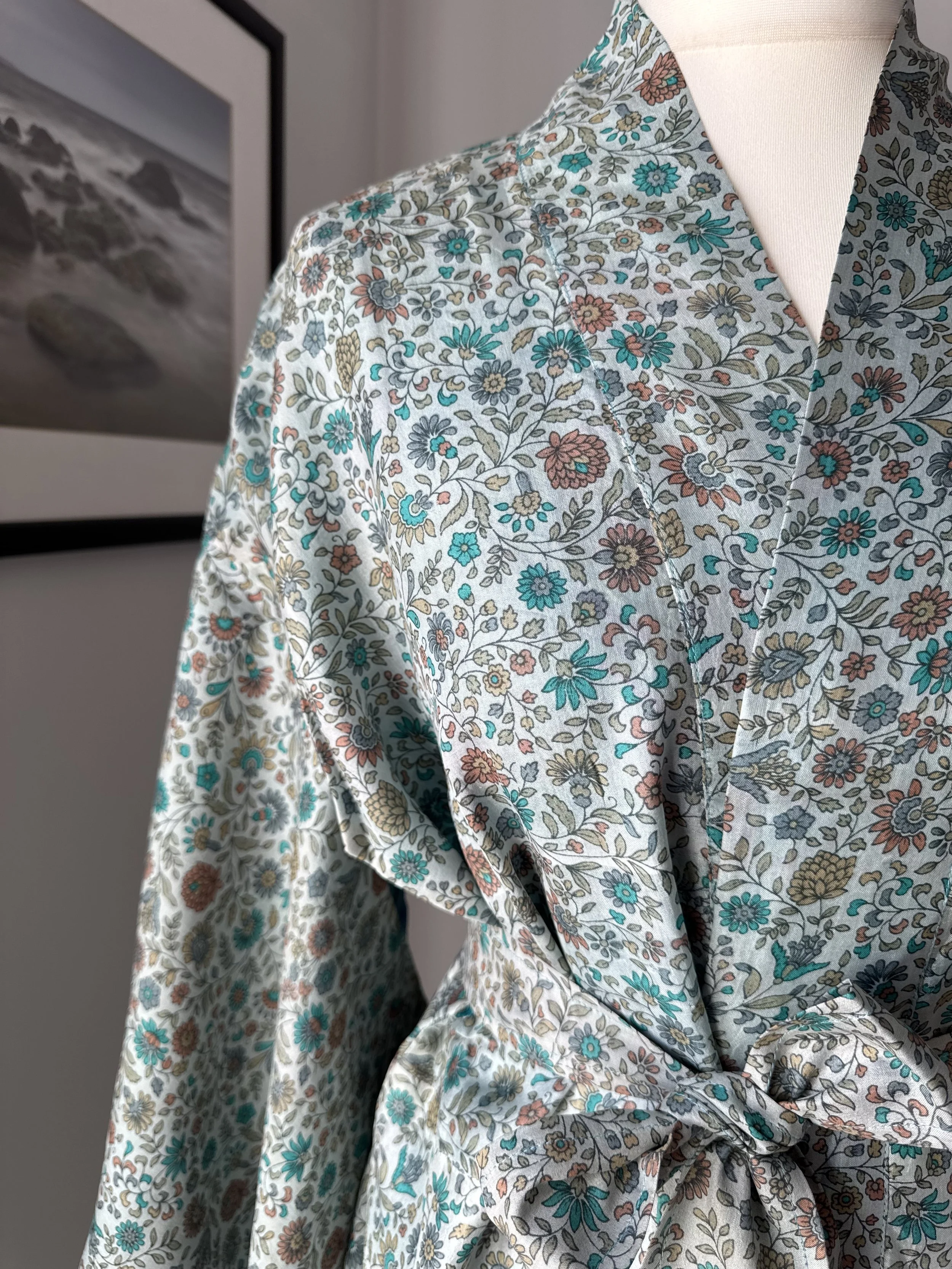 Close up of floral print in blue and cinnamon on recycled sari silk kimono robe
