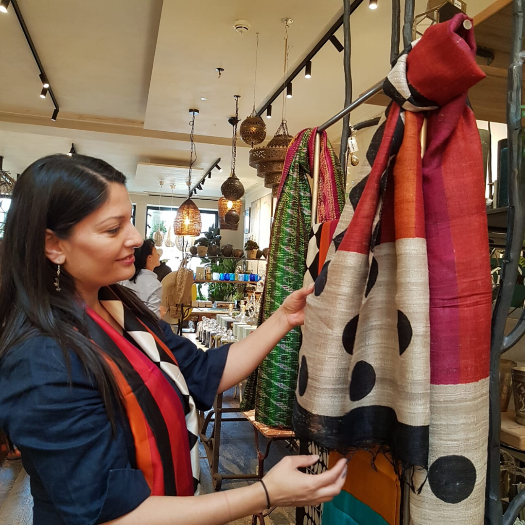 Harjit founder of Jewelled Buddha ethical fashion brand setting up at a pop up in Petersham nurseries London