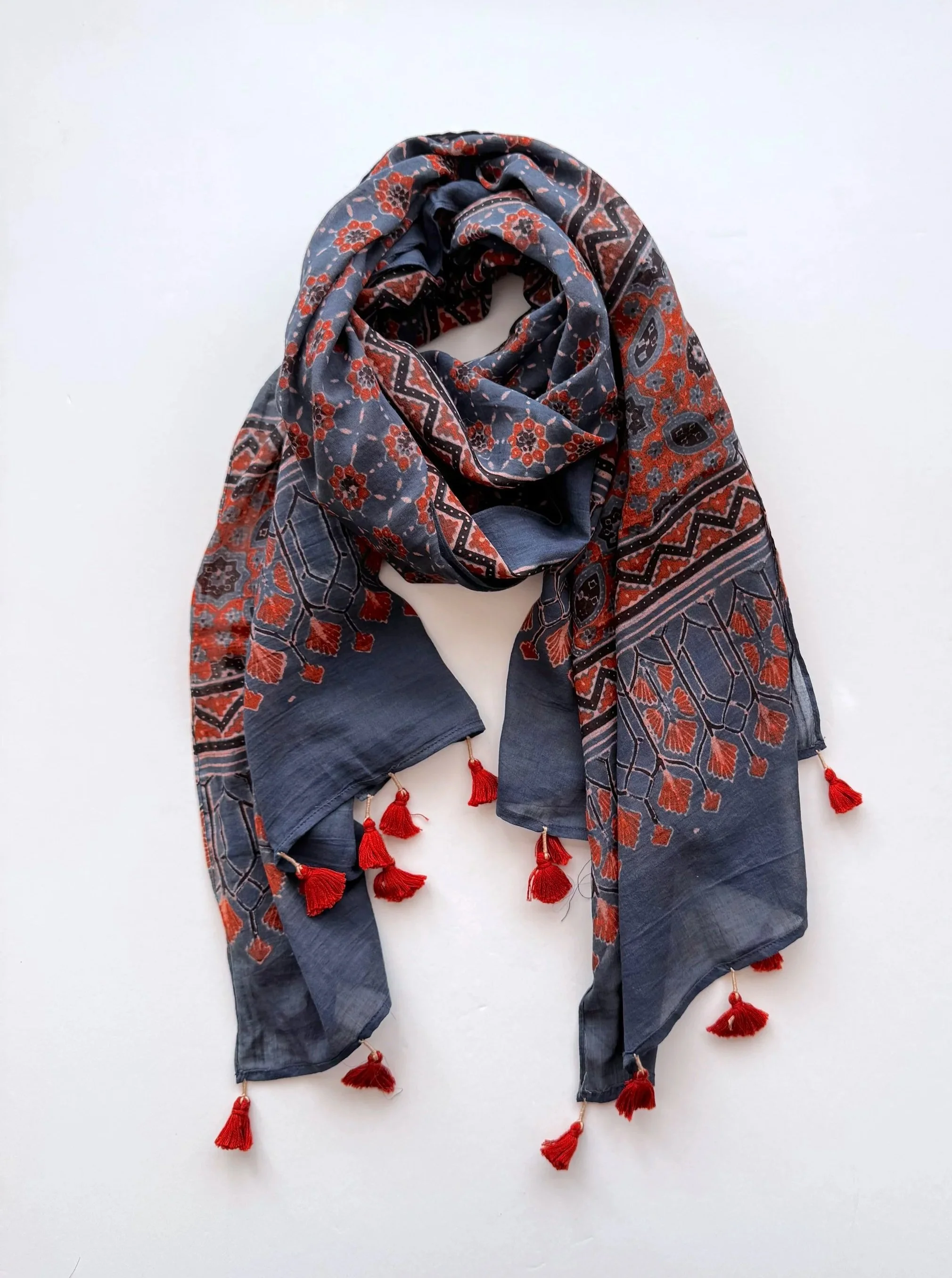 Hand block printed Ajrakh scarf in indigo, rust red and black, wrapped in soft folds