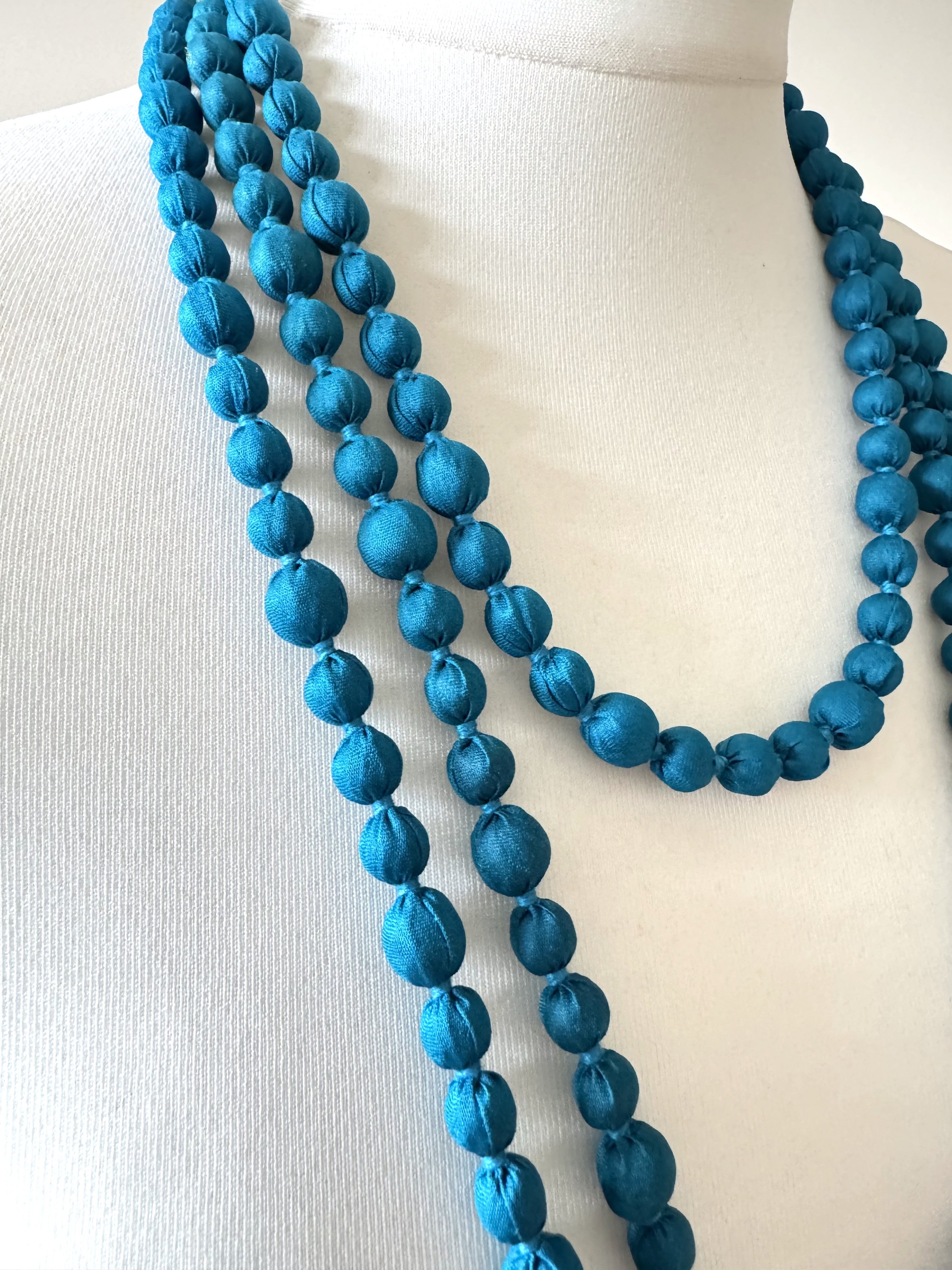 Close up of blue sari bead necklace