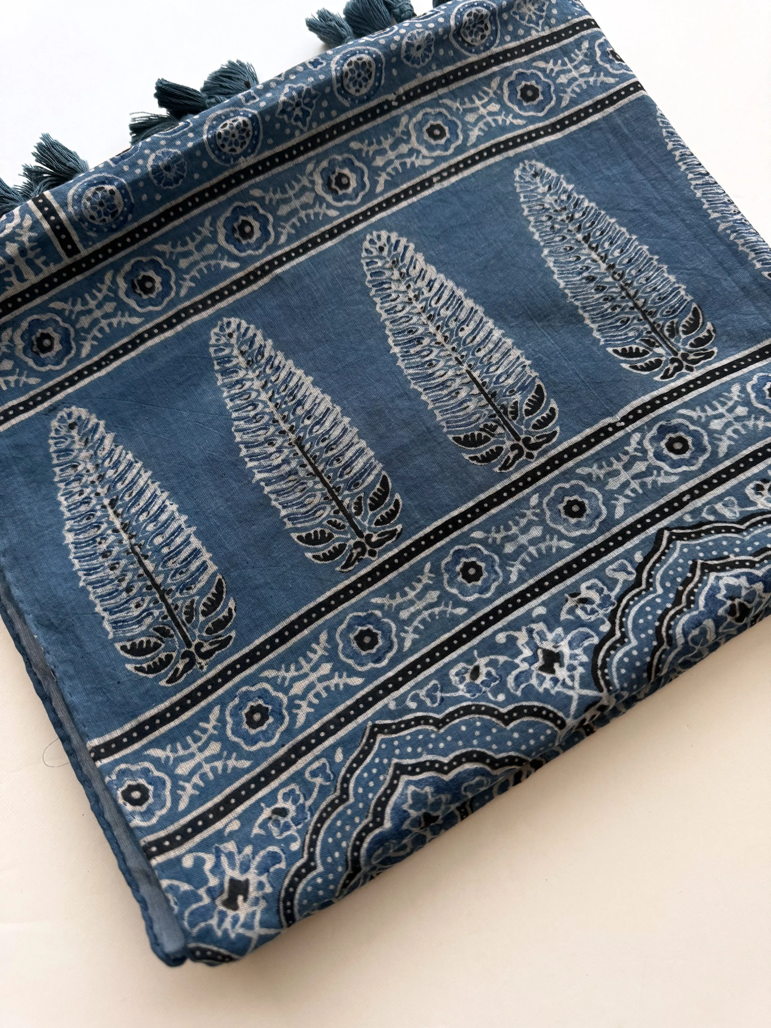 Handblock printed Ajrakh pattern detail on soft mulmul cotton scarf, showing natural indigo dye and iron black outlines