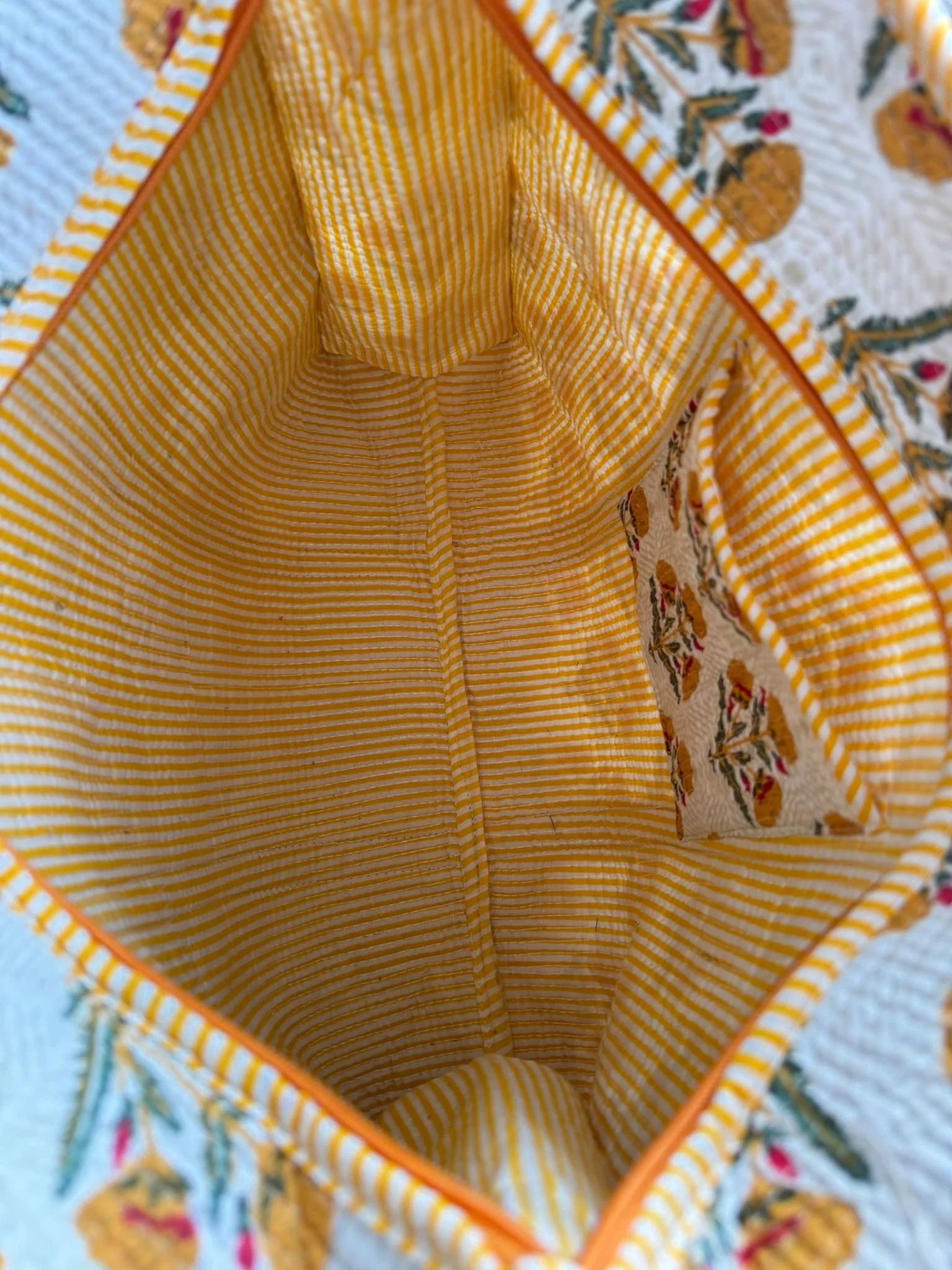 Yellow striped lining in a floral print quilted tote bag