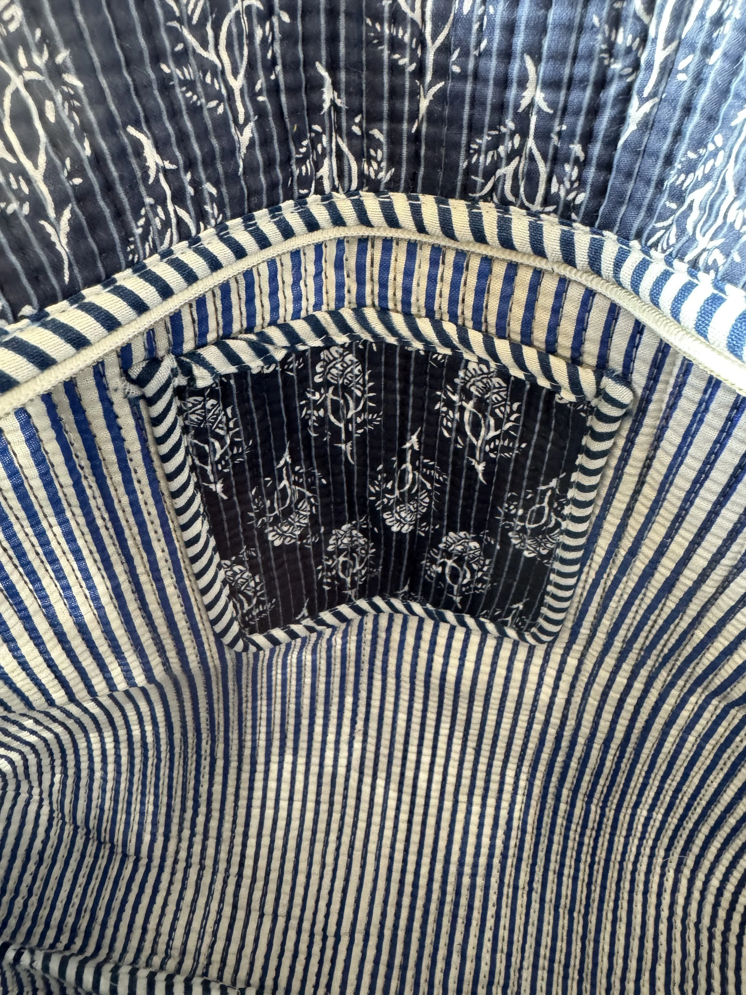 Spacious striped lining and inside pocket of handmade navy blue cotton tote bag, showing organised interior