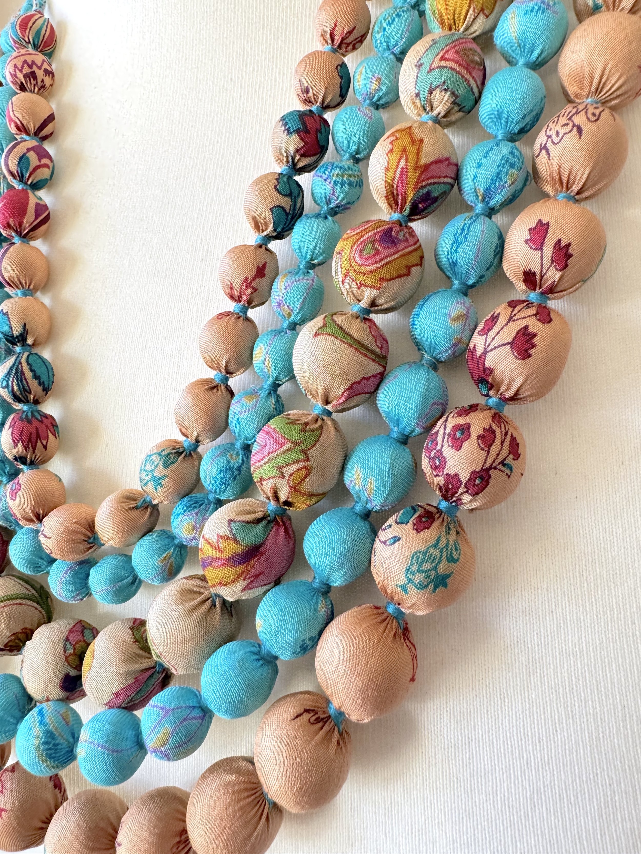 Pretty upcycled sari silk bead necklace with 5 layers of wood beads hand wrapped in recycled colourful floral print, sari silk