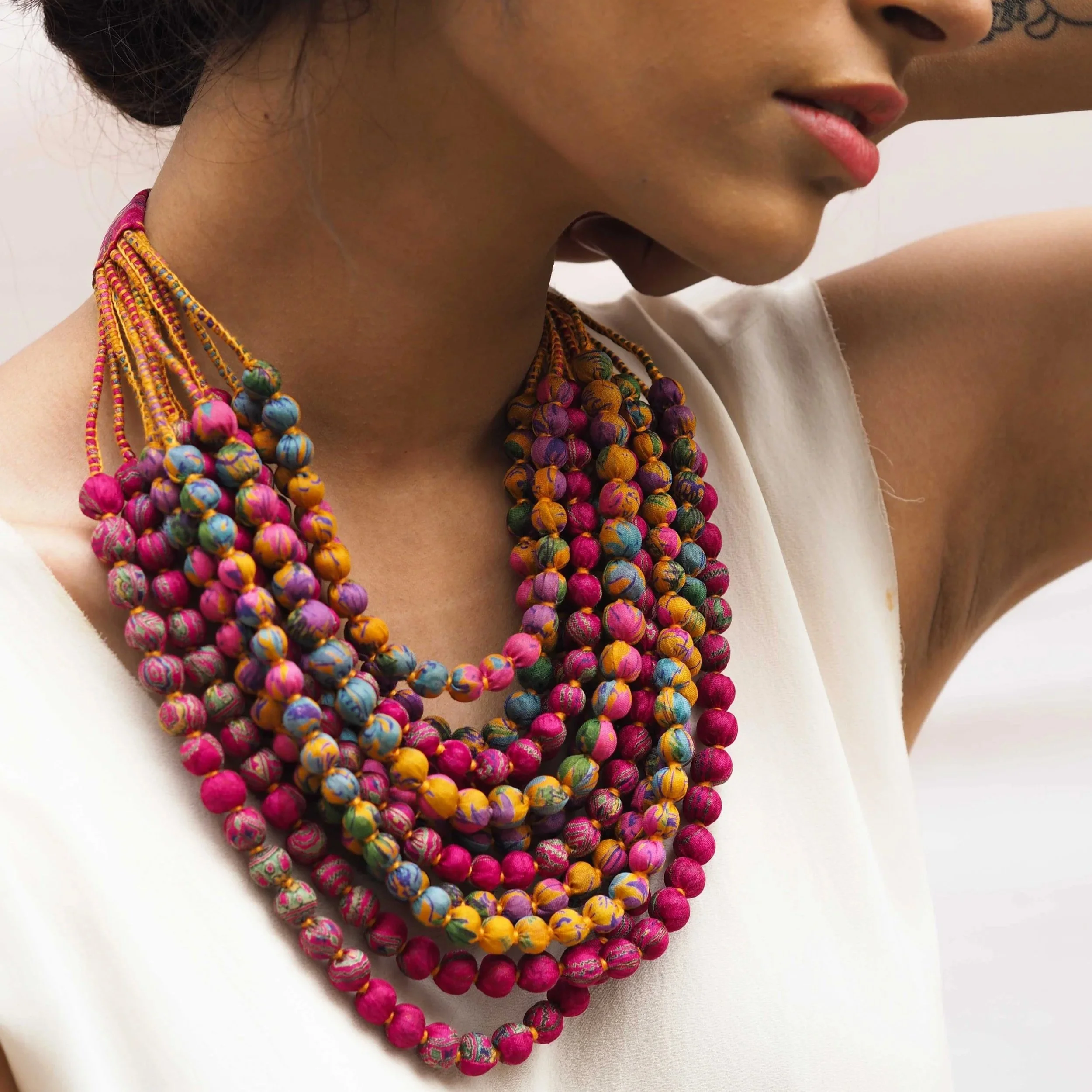 Woman wearing colourful multi-bead necklace