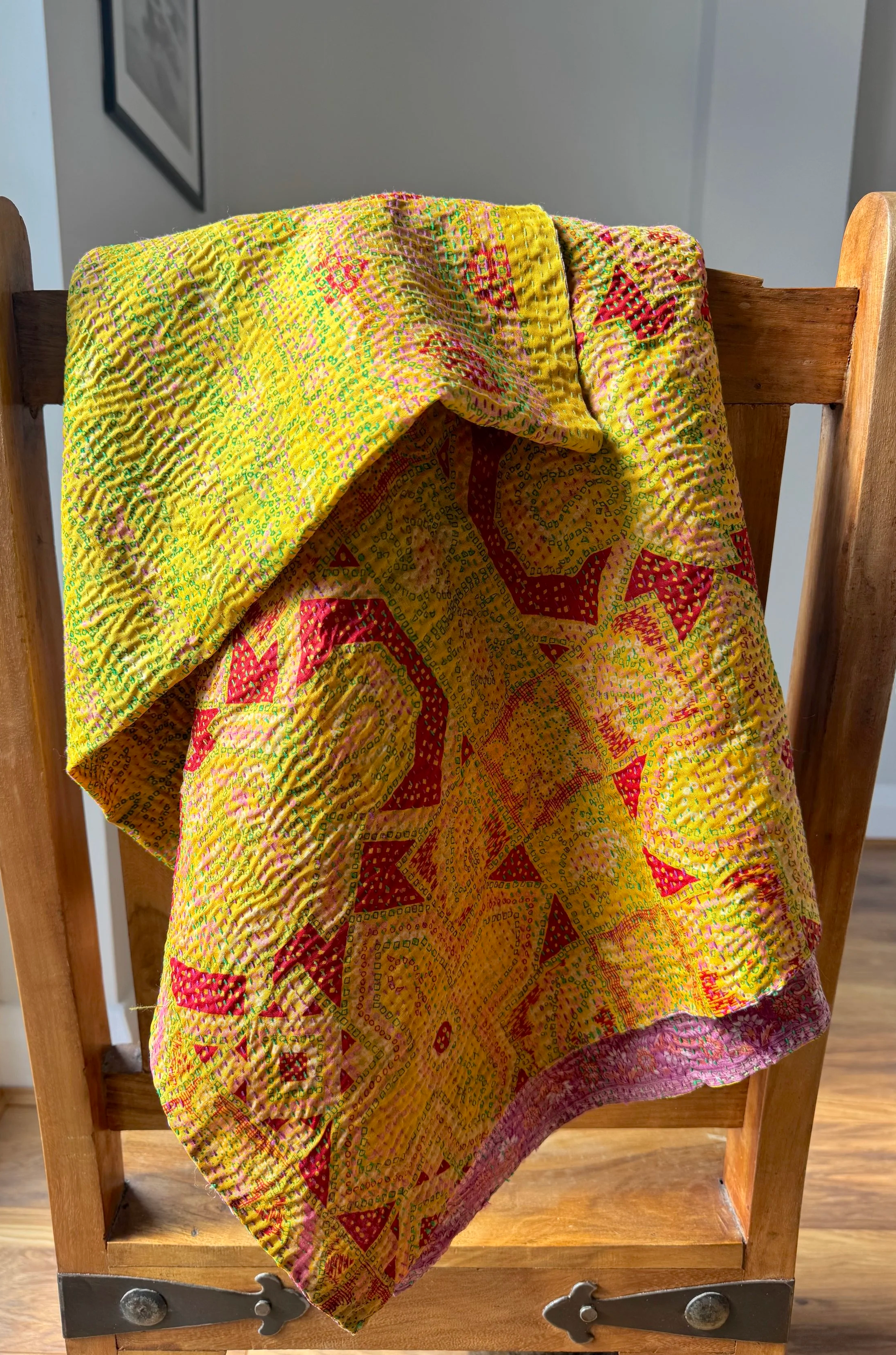 bright-yellow-quilted-kantha-scarf-draped-over-chair.png