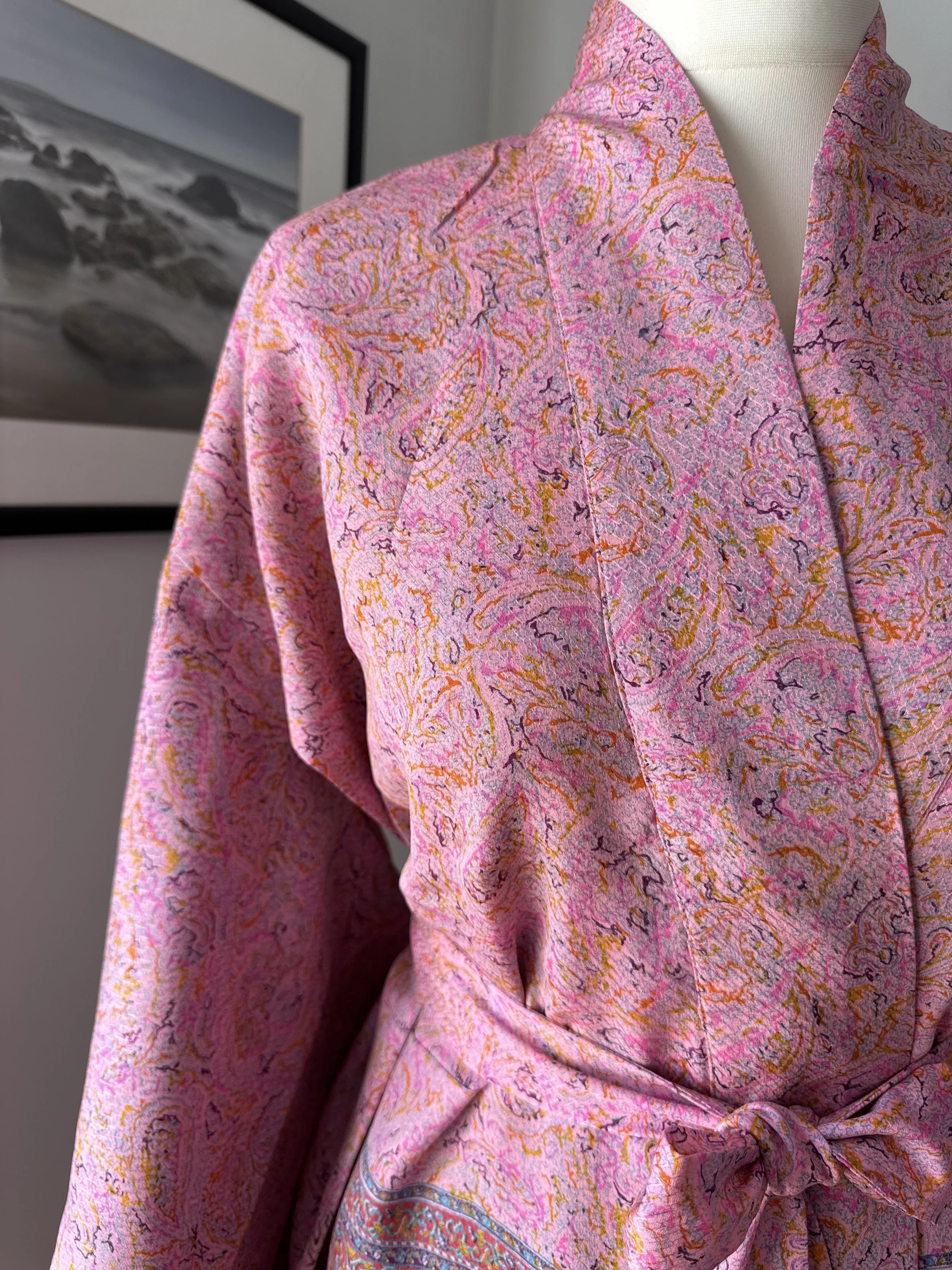 Close up of silk robe made from upcycled sari silk with colourful paisley print and silk belt