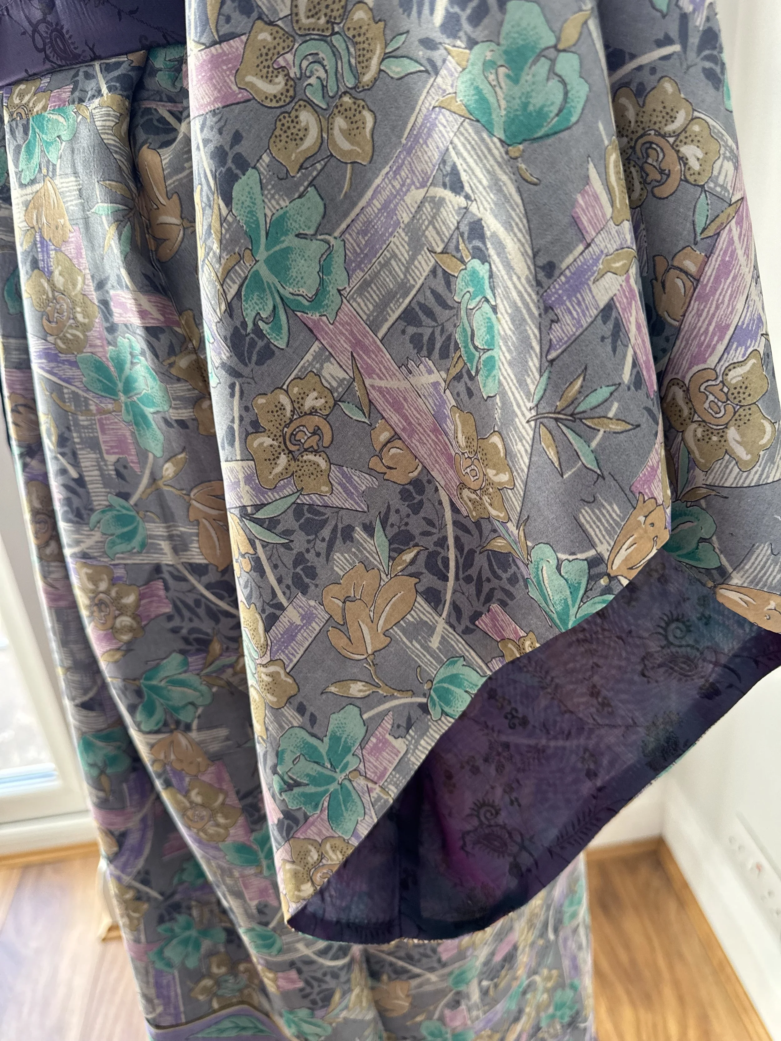 Colourful kimono sleeve in light grey with pink and blue flowers and contrast purple lining