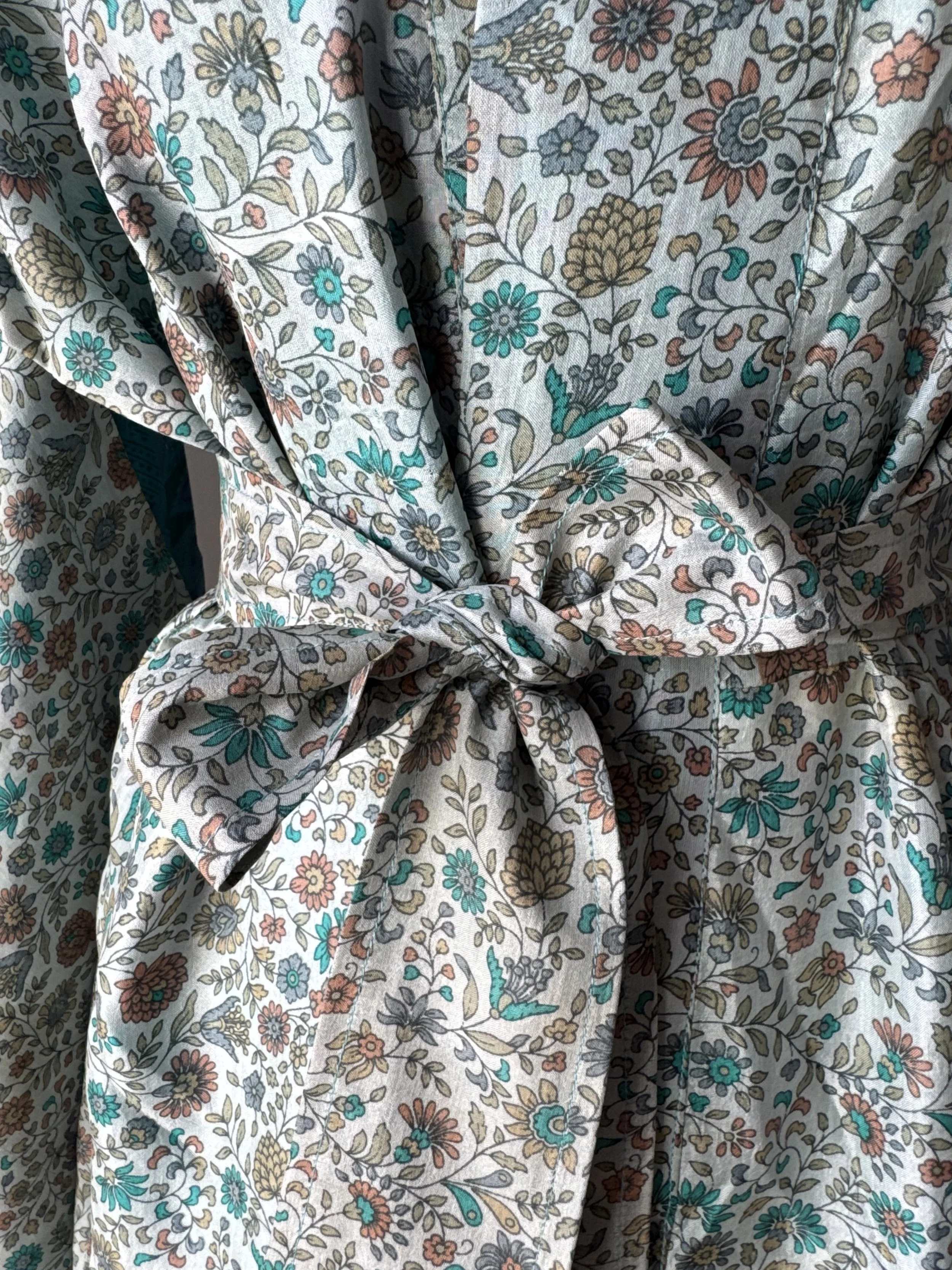 Close up of beautiful floral design on recycled sari silk kimono robe by Jewelled Buddha with pretty silk tie belt tied in a bow