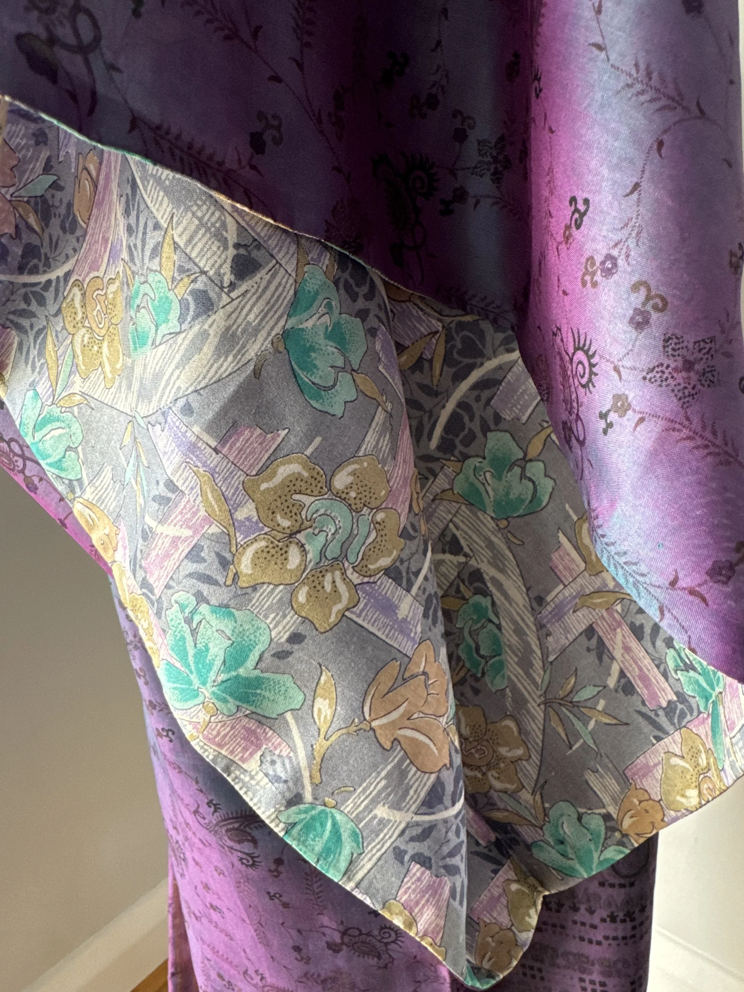 Close up of silk kimono sleeve in purple with contrasting light grey inside lining featuring colourful blooms