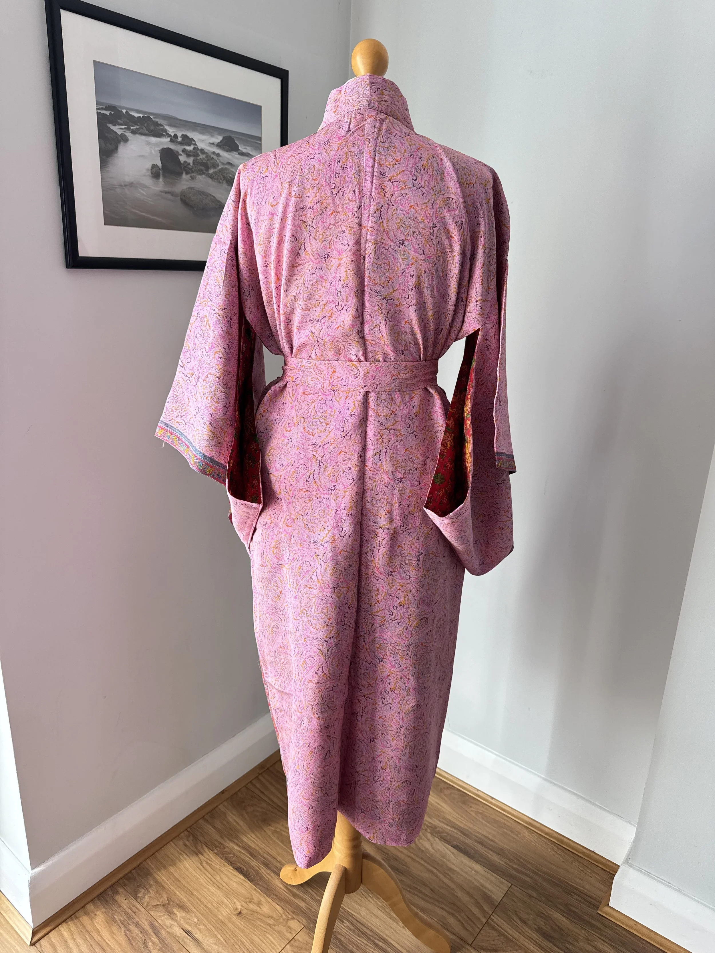 Back view of pink silk sari kimono robe with flowing kimono sleeves, wrap over front and contrasting lining