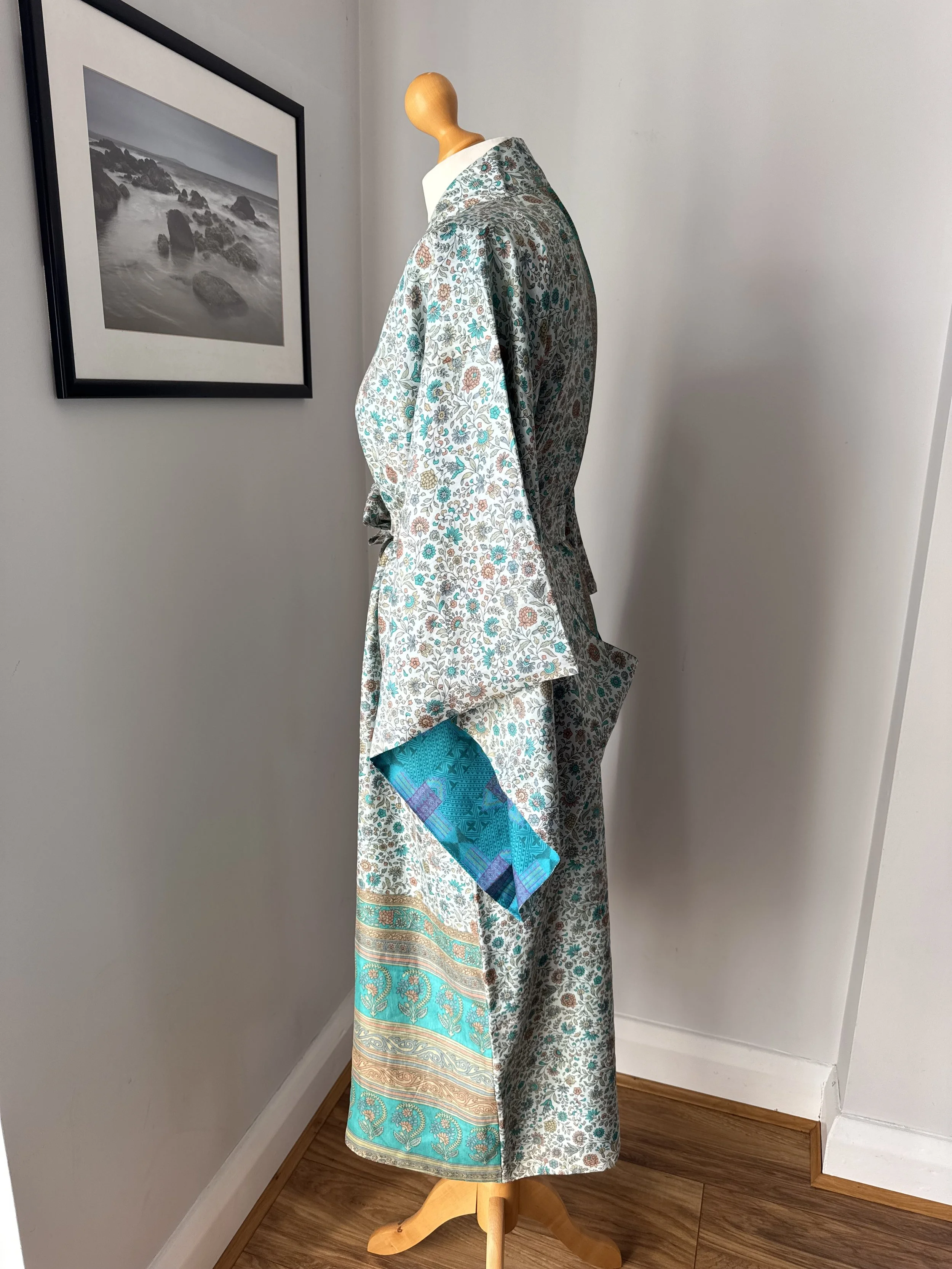 Side view of summer silk kimono robe in turquoise and cinnamon floral print with flowing kimono sleeves and silk tie belt