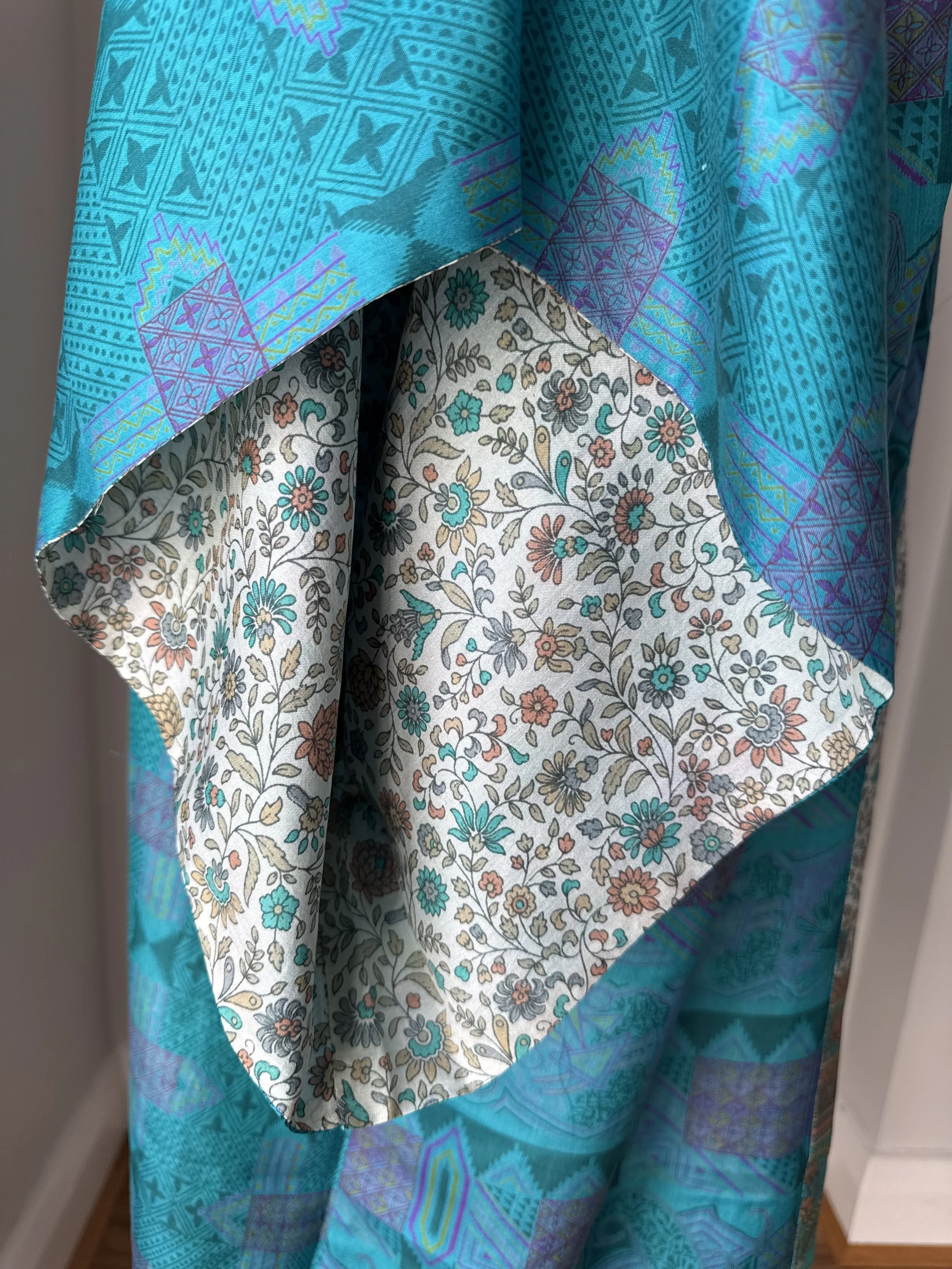 Close up of kimono sleeve on recycled sari silk robe, showing contrasting floral lining