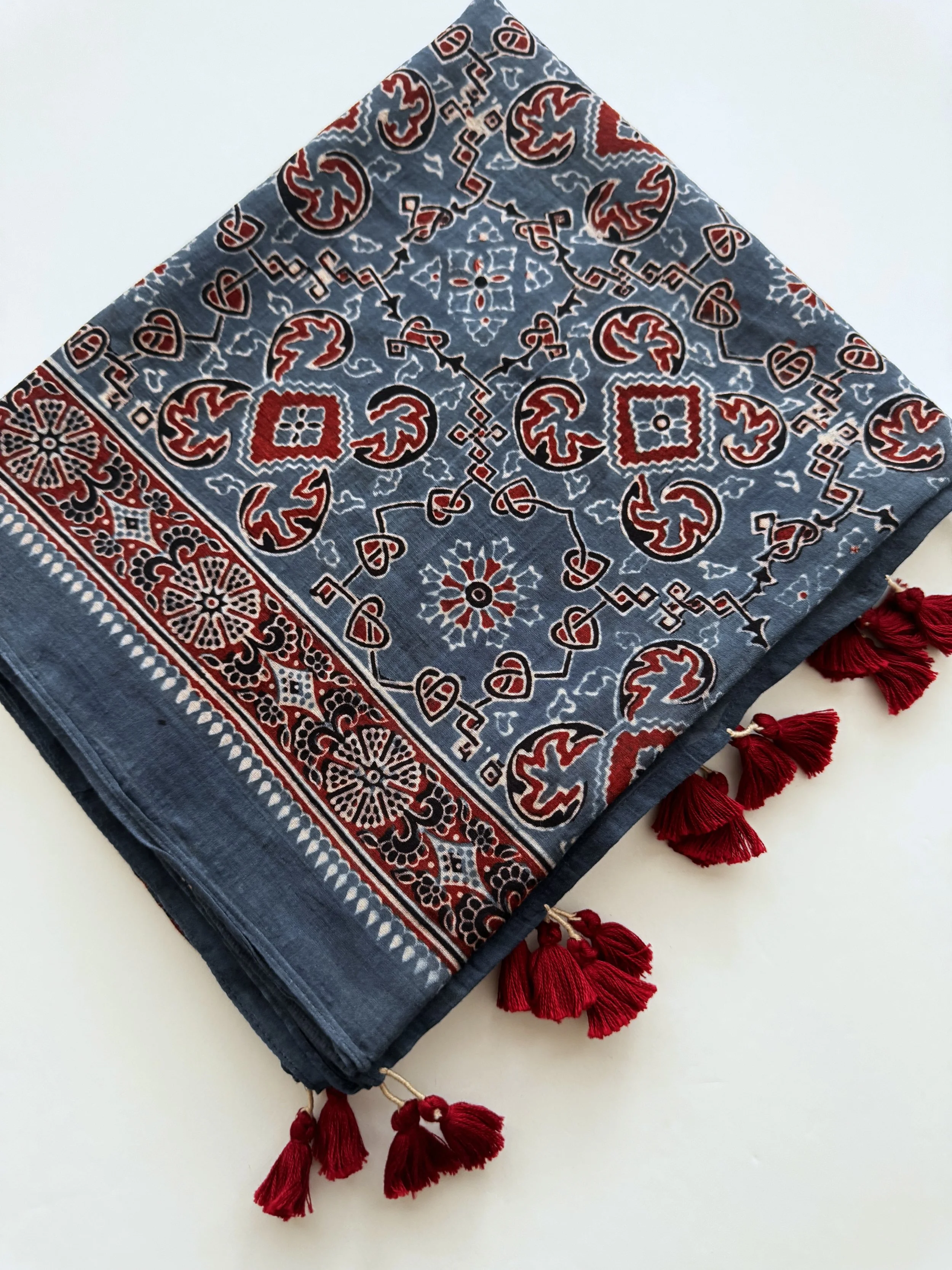 Close-up of hand block printed Ajrakh pattern in indigo, madder red and black on soft mulmul cotton