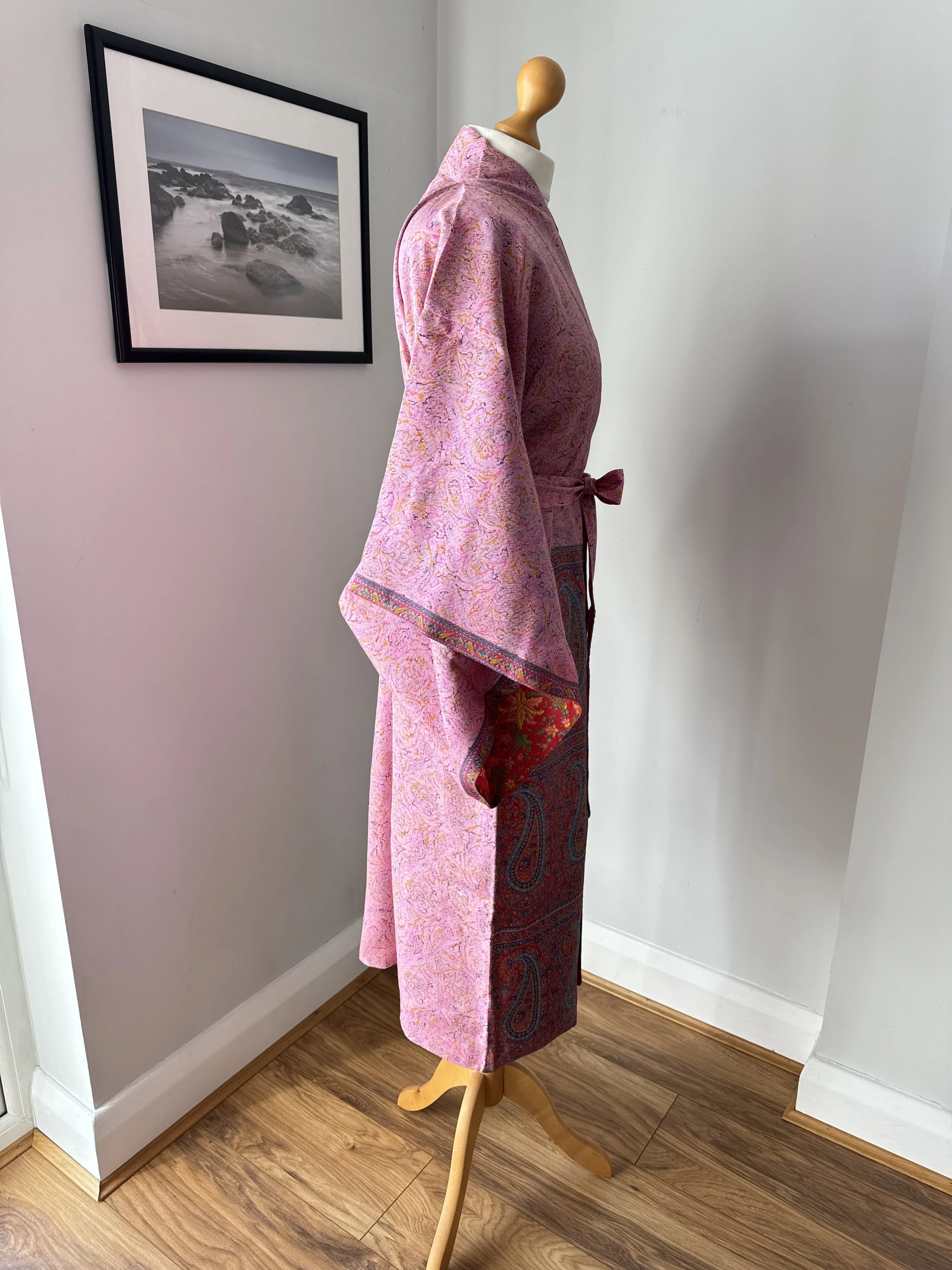 Side view of silk sari kimono robe with flowing kimono sleeves, wrap over front and contrasting red floral lining
