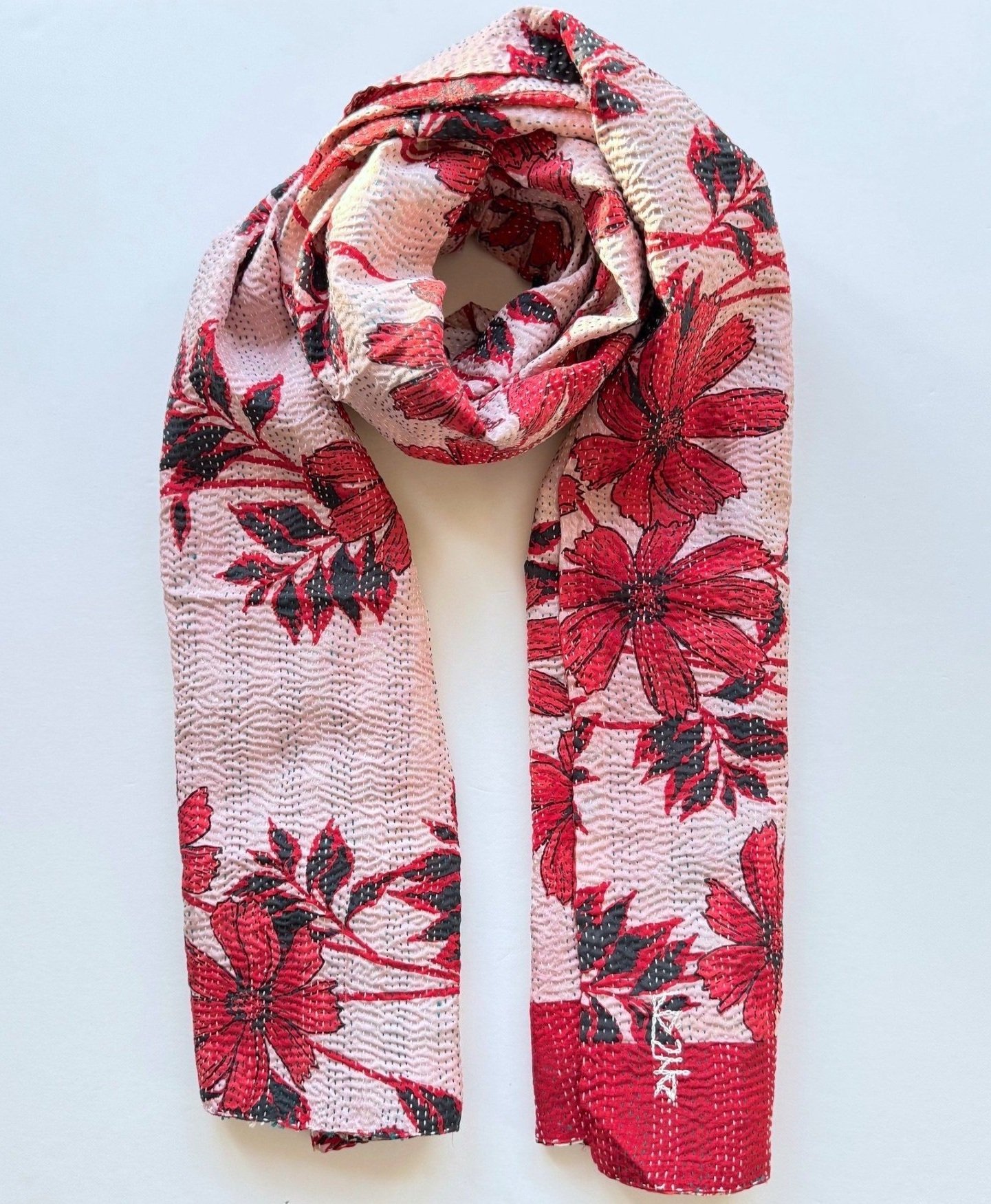 Upcycled sari kantha scarf with large red flower print wrapped on a grey background