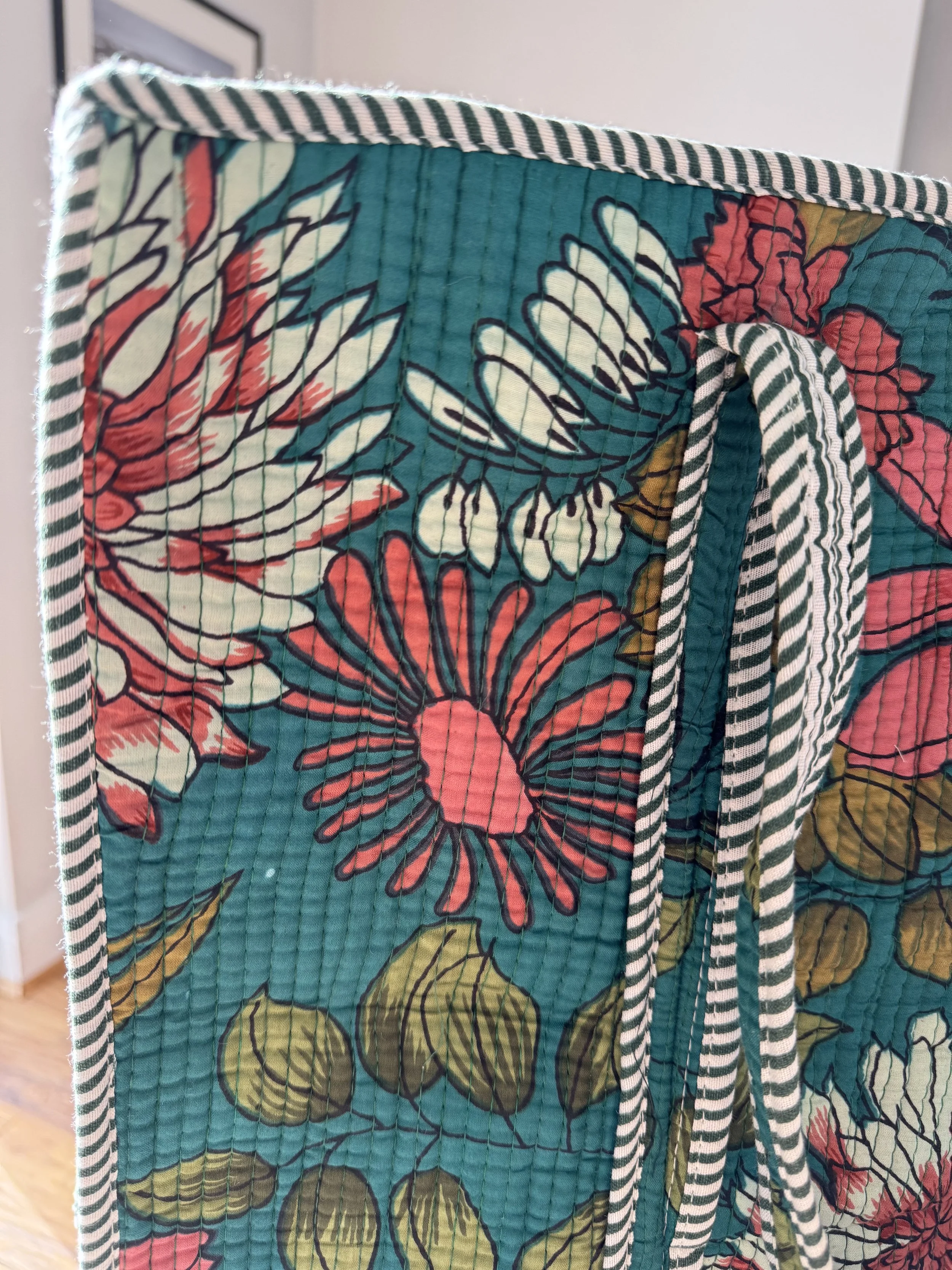 Close up of colourful flower print on  screen printed quilted cotton tote bag with contrasting trim