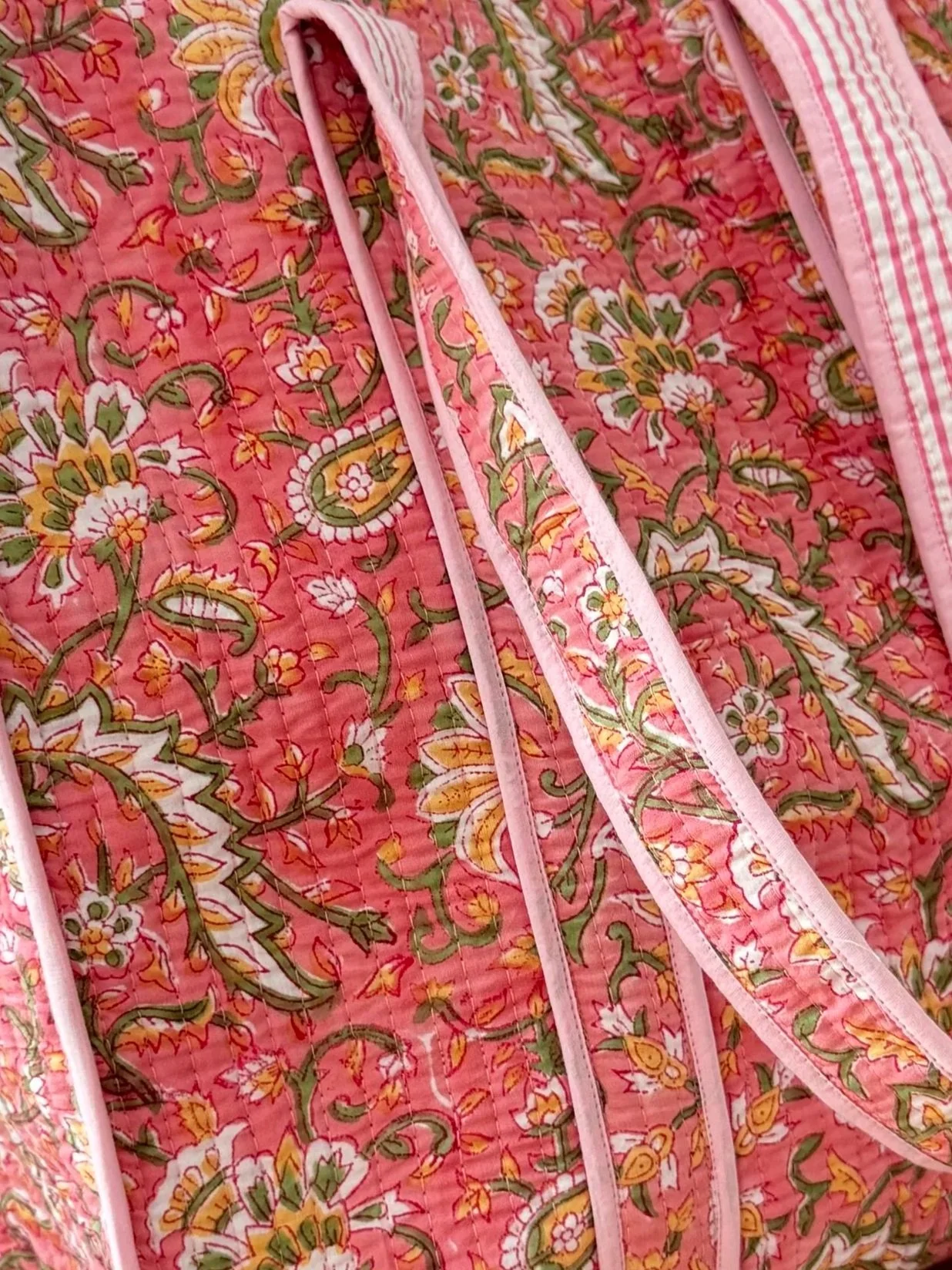 Handmade block print quilted cotton tote bag in pink with intricate floral design, pink striped handles and soft pink piping by Jewelled Buddha