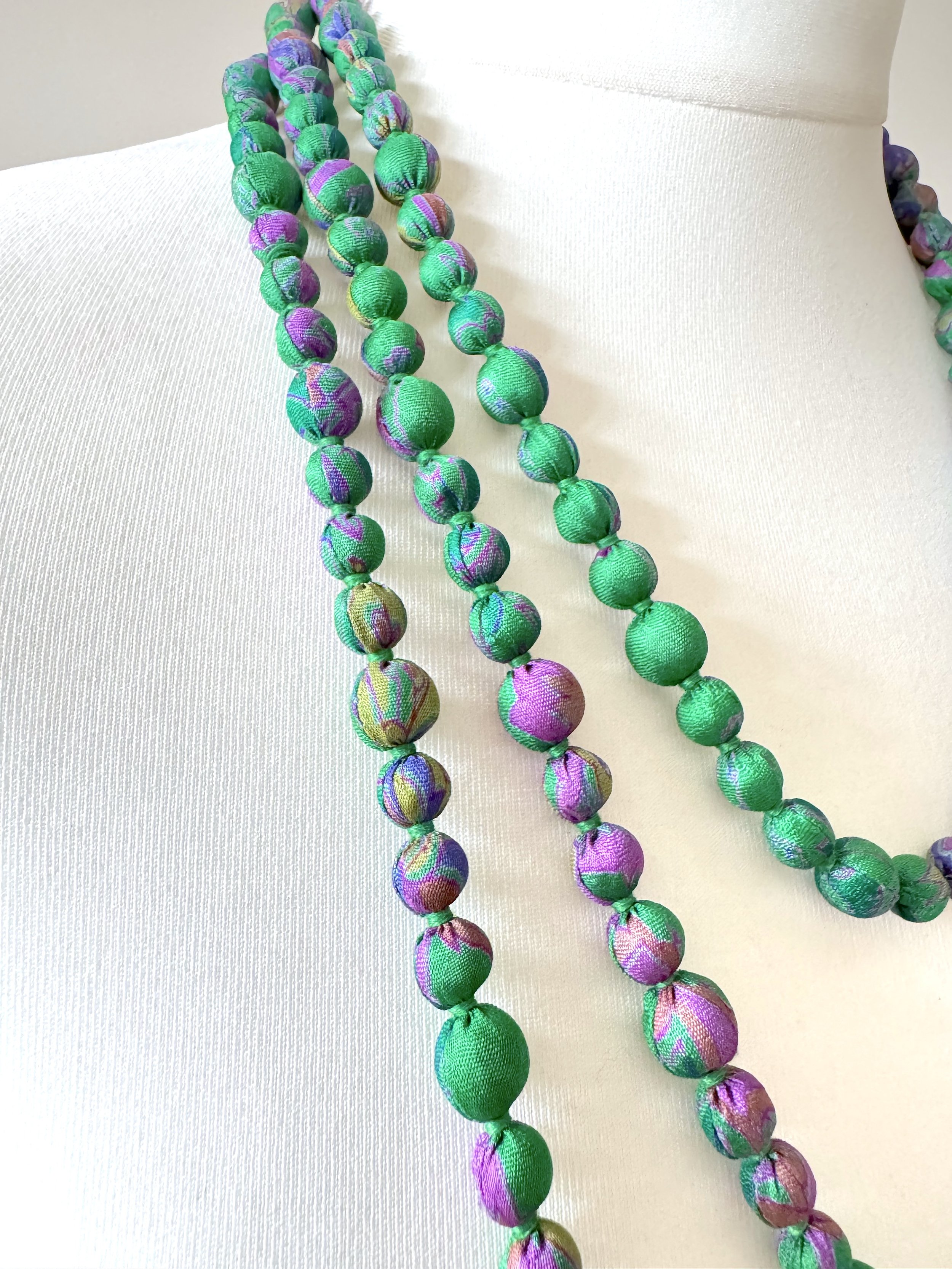 Close up of green sari silk wood bead necklace