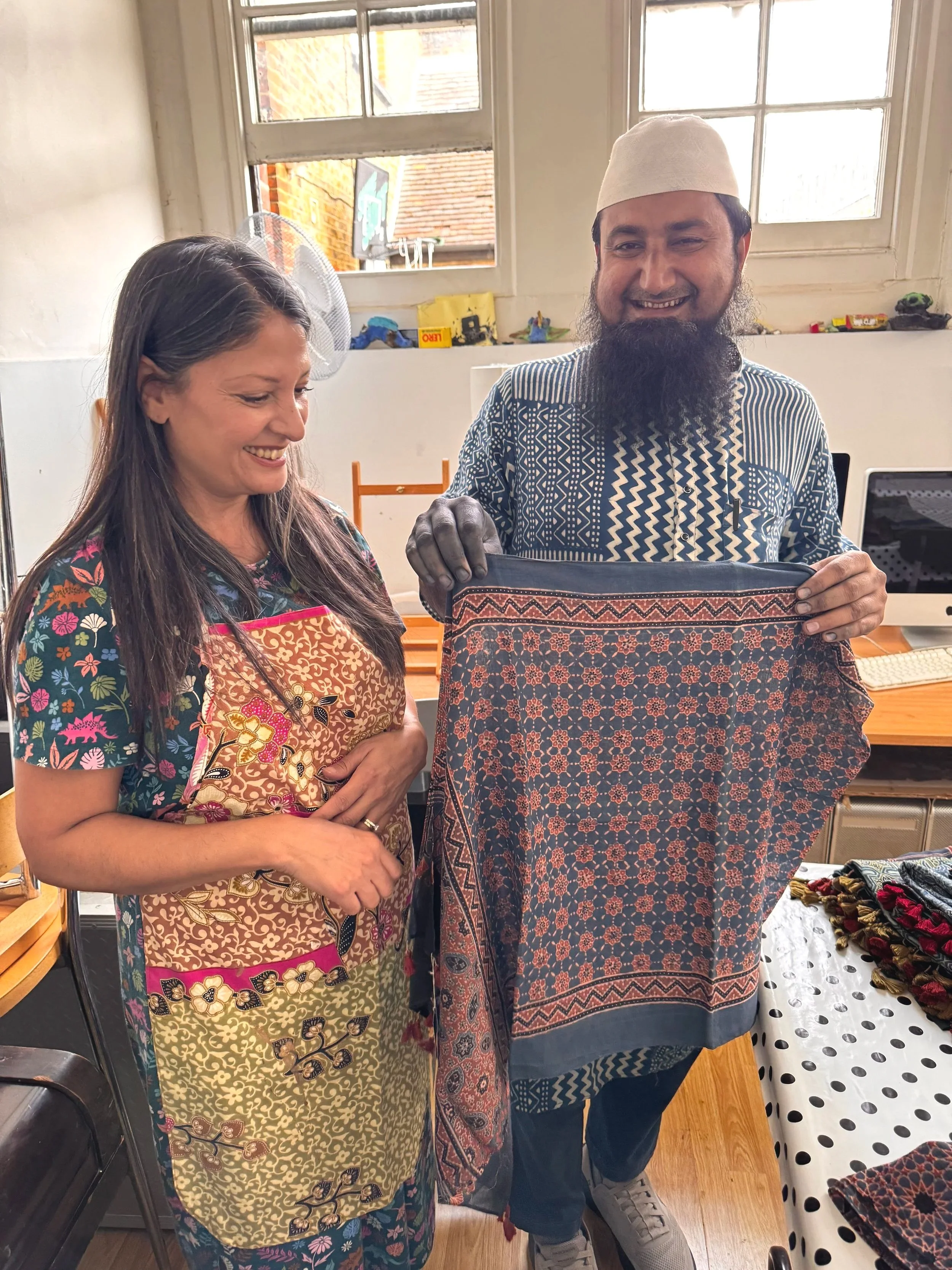 Harjit Sohotey-Khan founder of Jewelled Buddha and Sufiyan Khatri, a 10th generation Ajrakh master artisan who is holding up a Ajrakh scarf