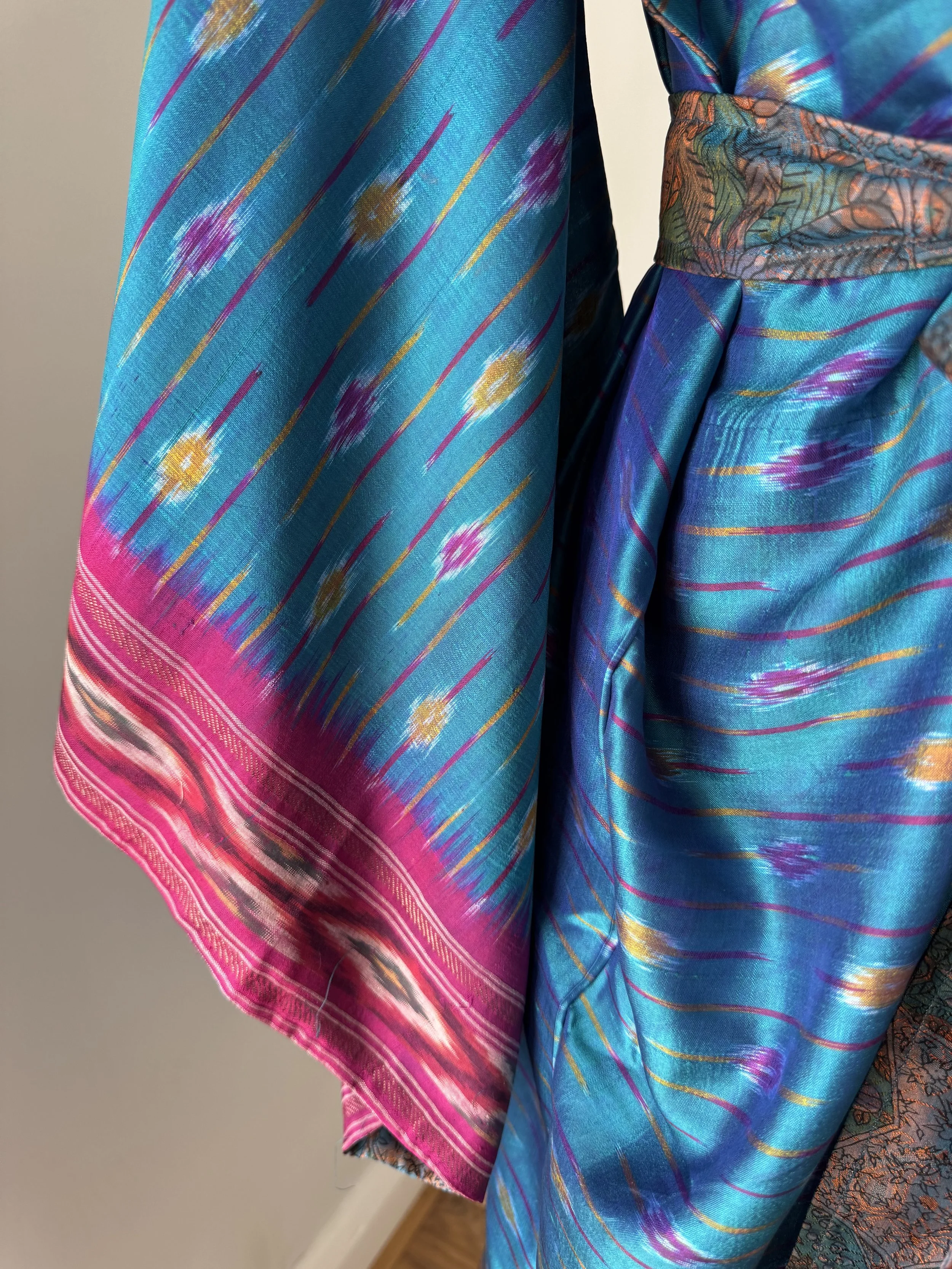 Striking pink kimono sleeves with contrasting blue and pink Ikat pattern