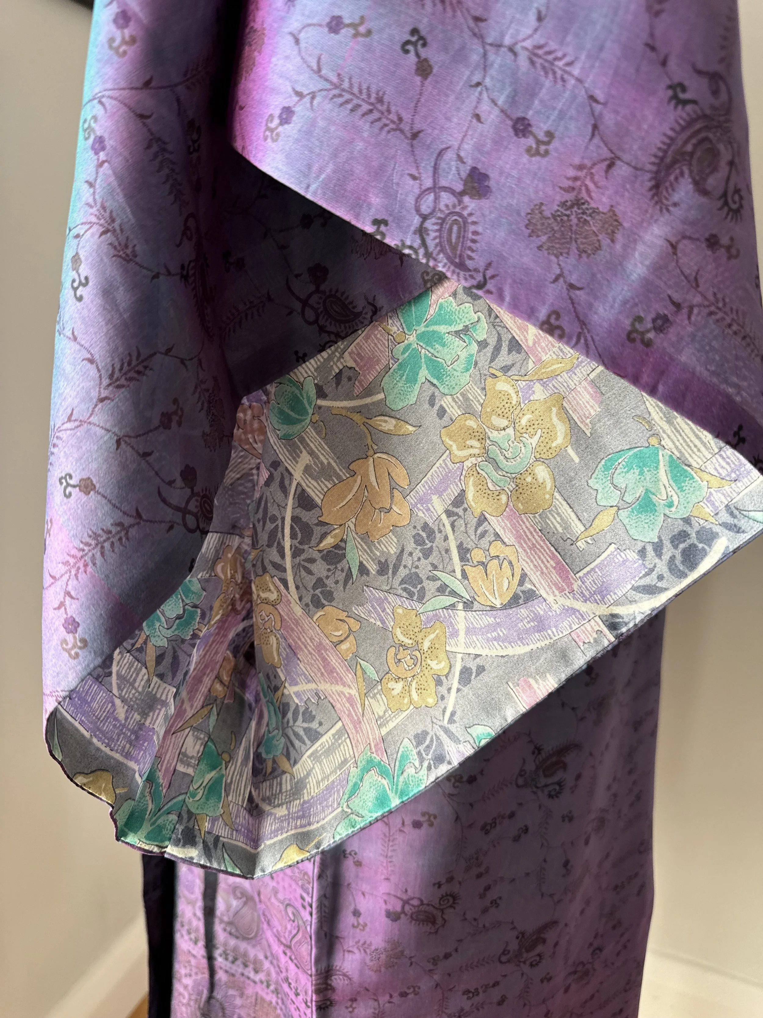Close up of silk kimono sleeve in purple with contrasting light grey inside lining featuring colourful blooms