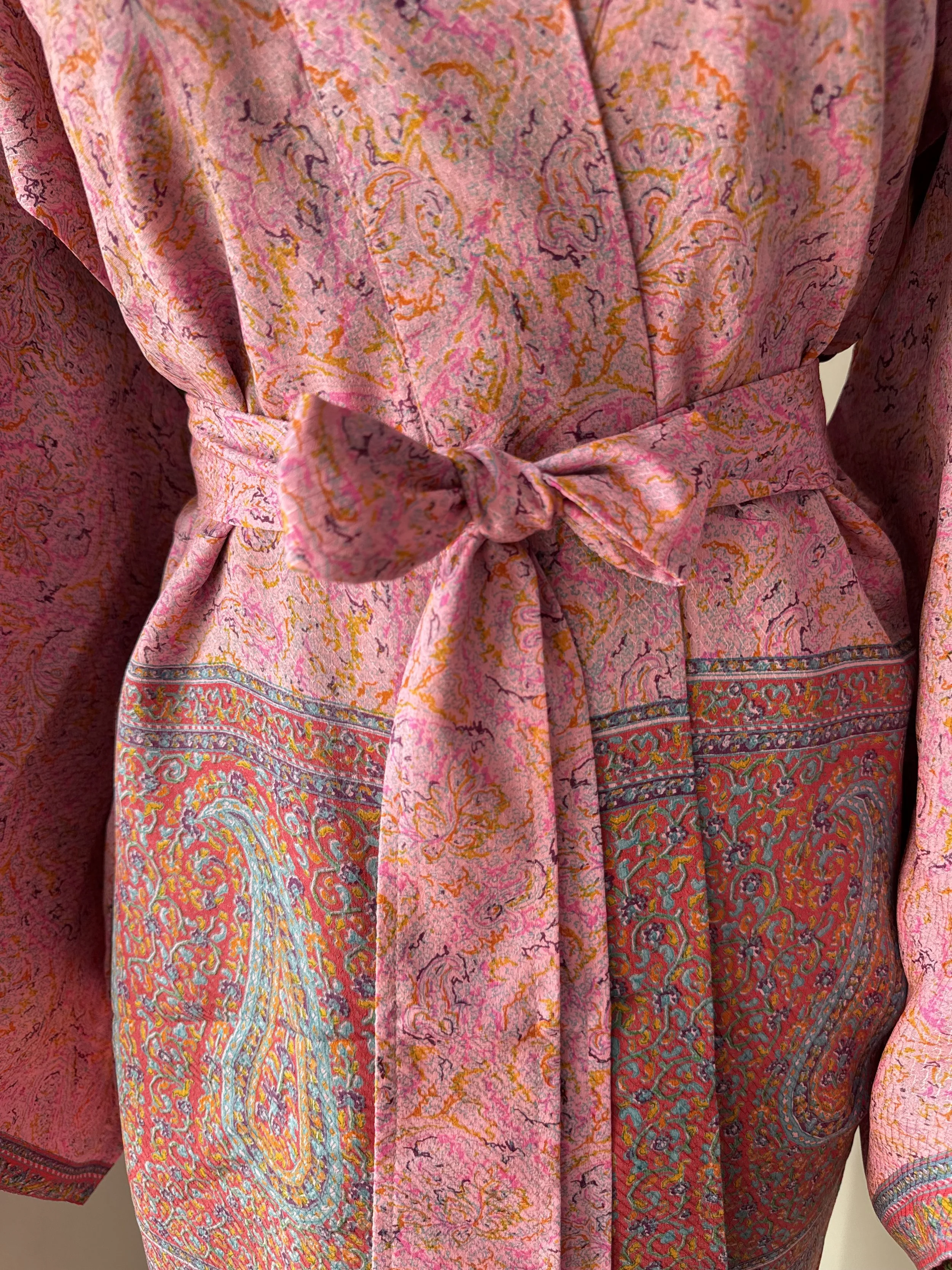 Close up of silk robe made from upcycled sari silk with colourful paisley print and silk belt