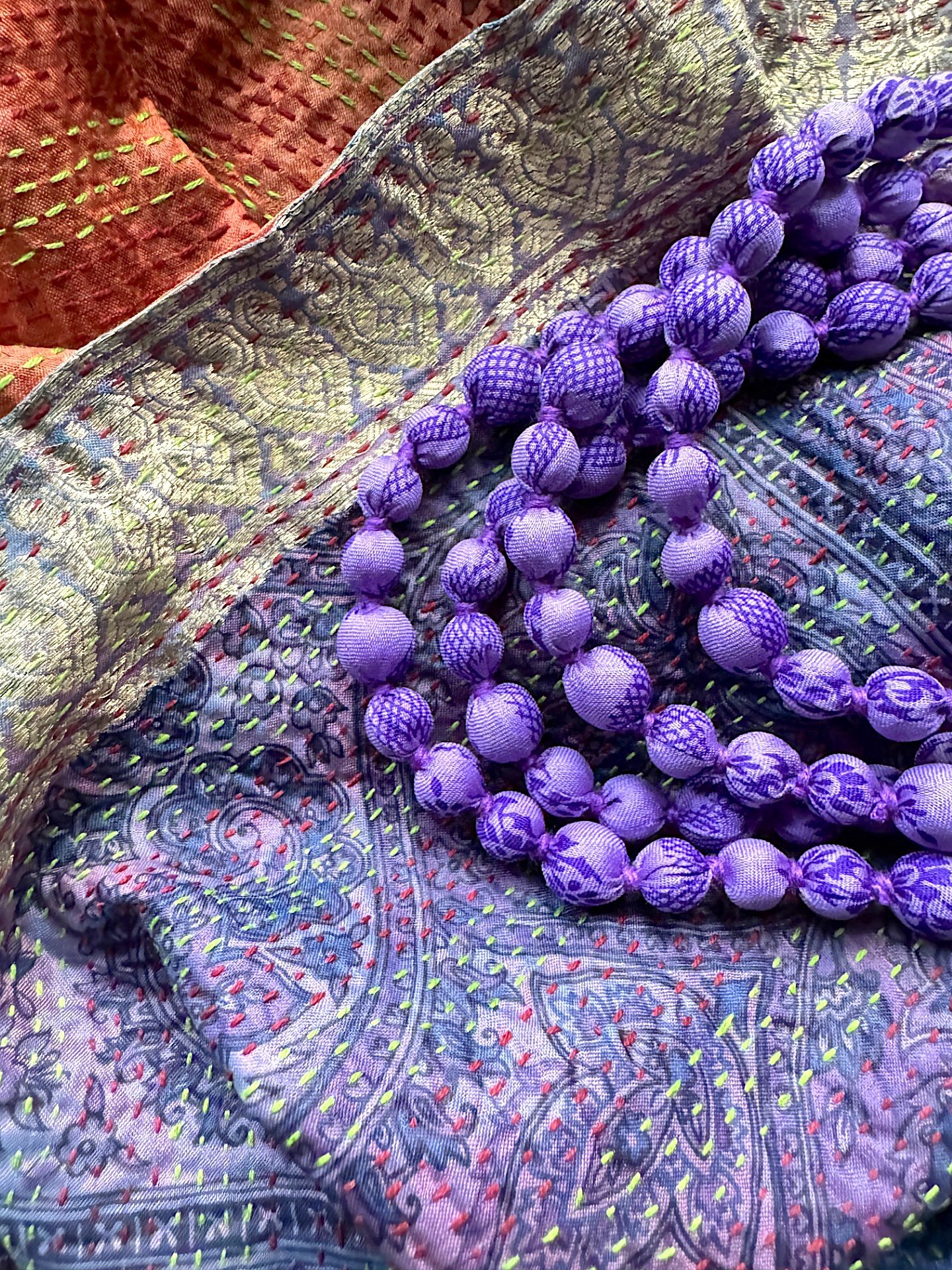 amethyst-sari-bead-necklace-on-kantha-fabric.jpeg