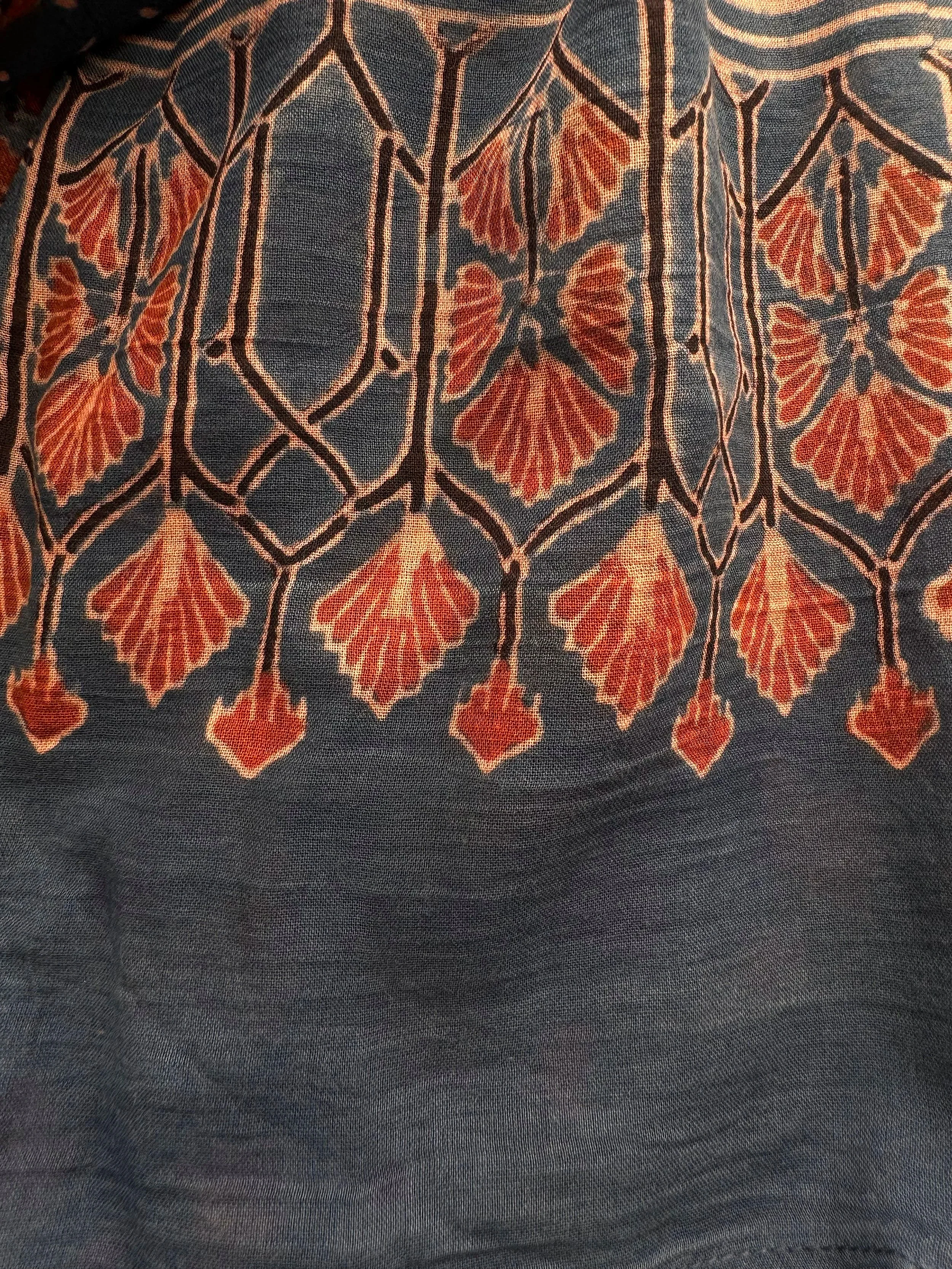 Close up of floral Ajrakh pattern on indigo dyed soft cotton scarf