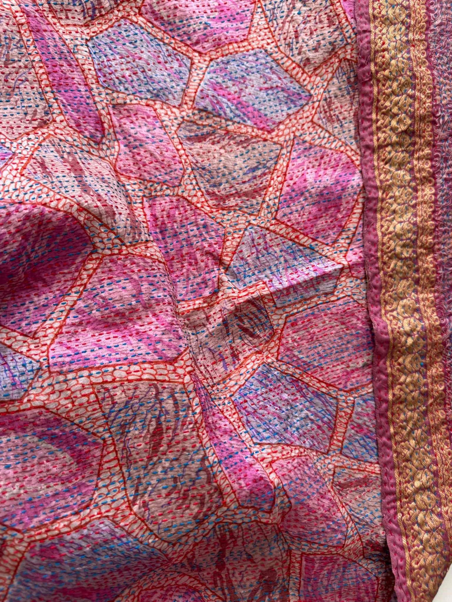 Colourful kantha fabric in bright pinks and purples with abstract print