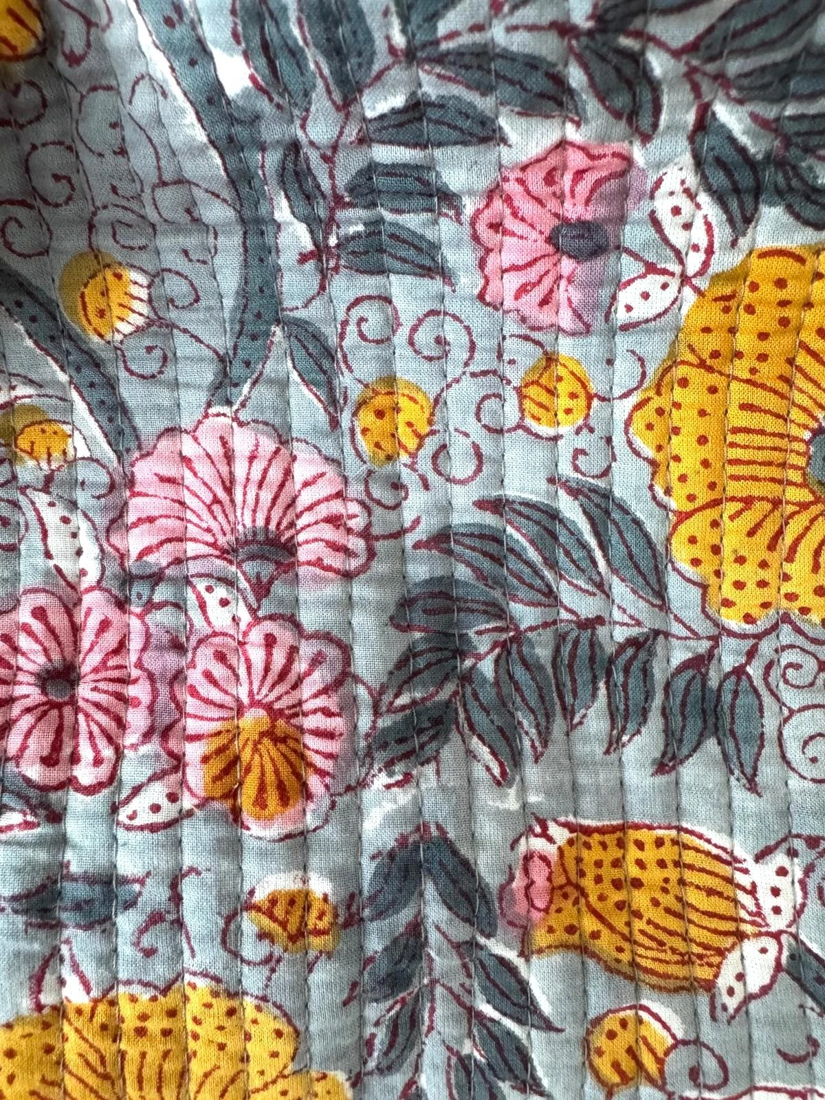 Close up floral block print design on handmade, quilted cotton toiletry bag