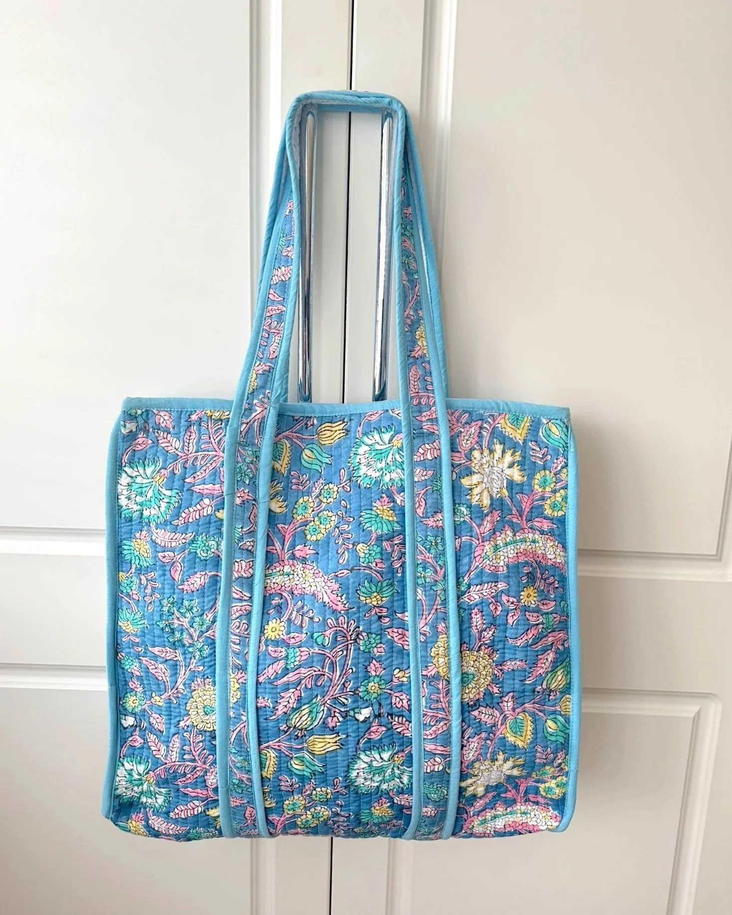 Handmade block print quilted cotton tote bag in sky blue with intricate floral design by Jewelled Buddha