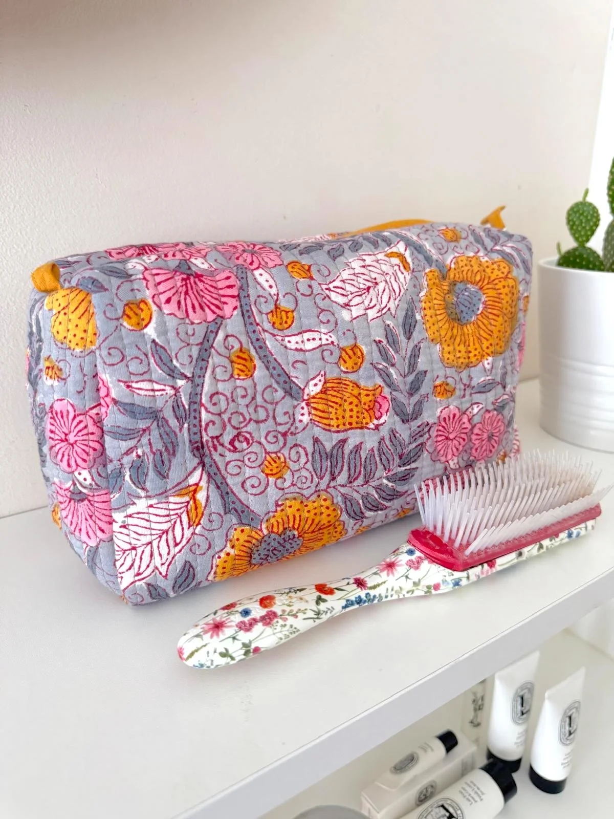 Large handmade block print wash bag in grey, pink and mustard floral quilted cotton artisan toiletry bag, ethically made in Jaipur.