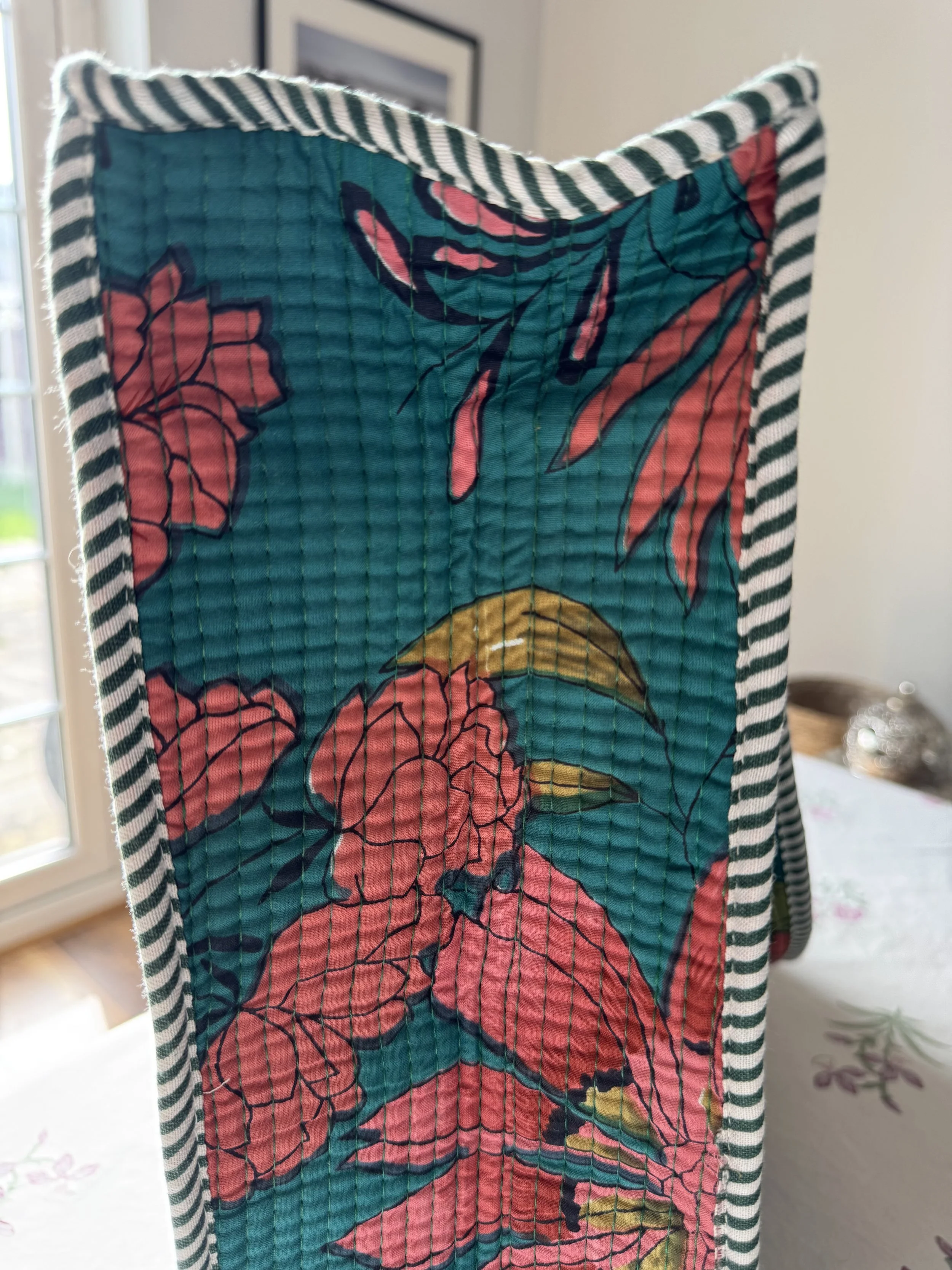 Close up of pink floral print on screen sprinted quilted cotton tote bag with contrasting striped trim