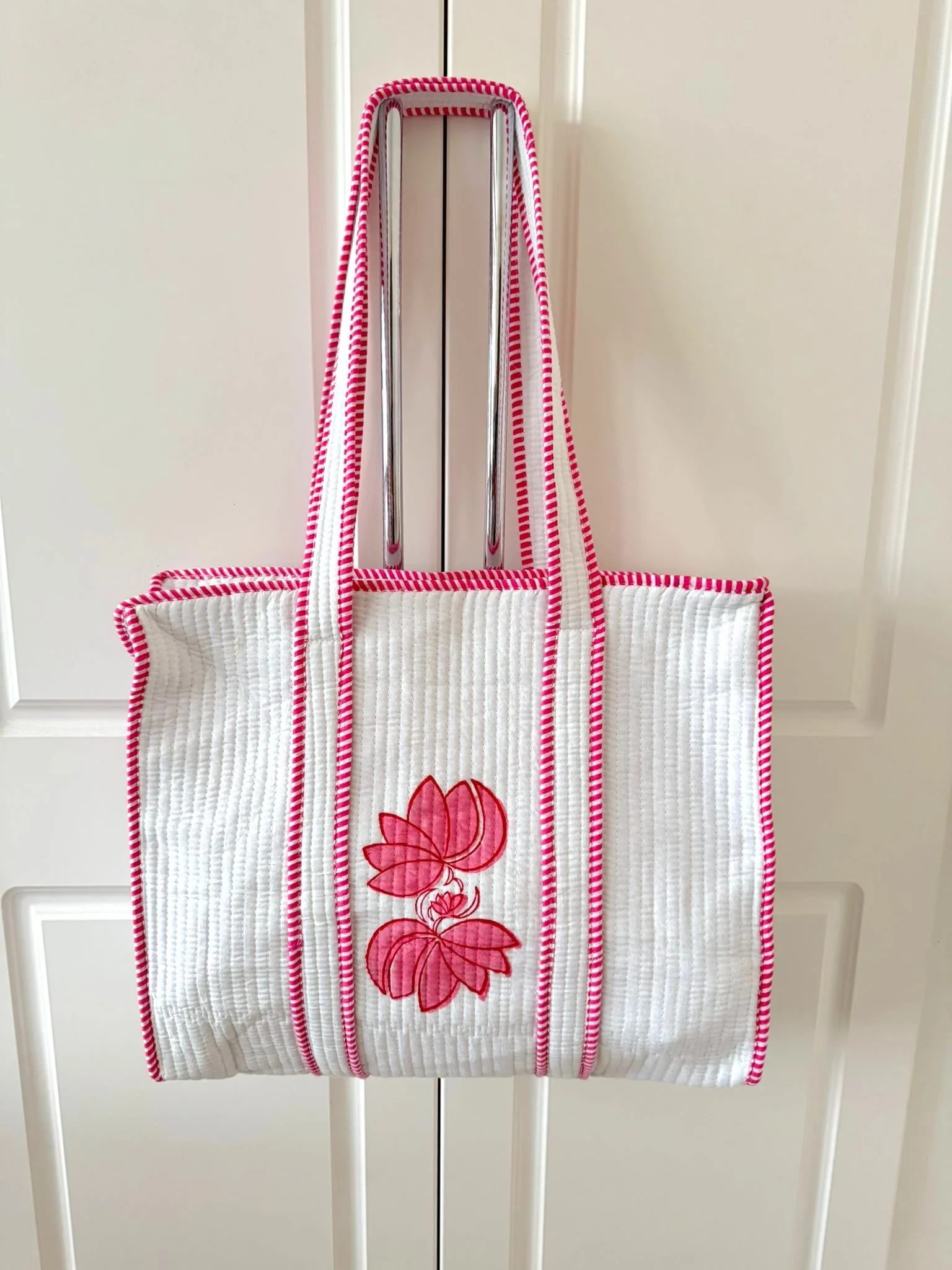 Pink block printed quilted cotton tote bag with pink striped shoulder straps and trim with side pocket