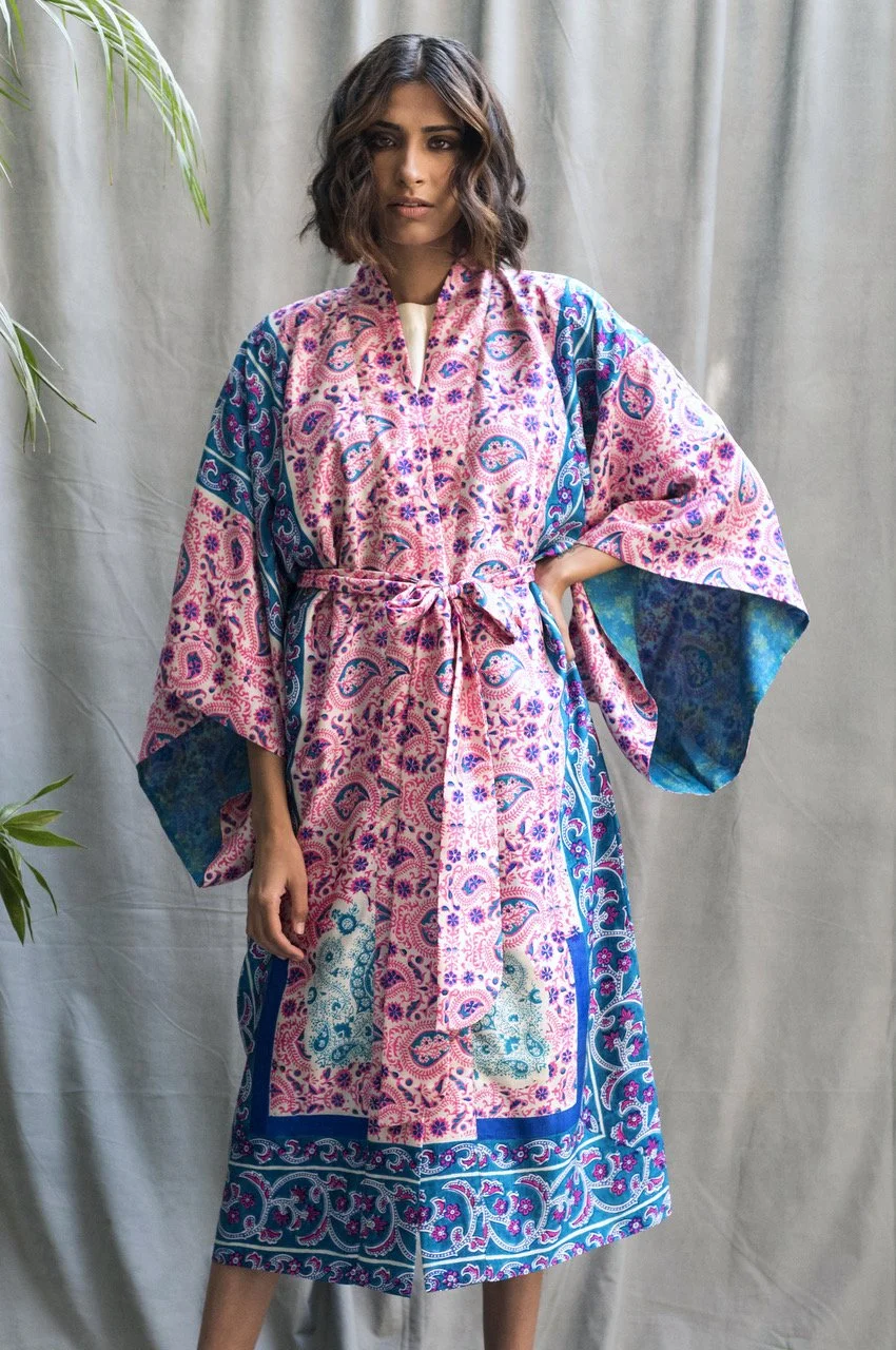 woman with her hand on her hip wearing a paisley print silk sari kimono bathrobe handmade from upcycled sari silk