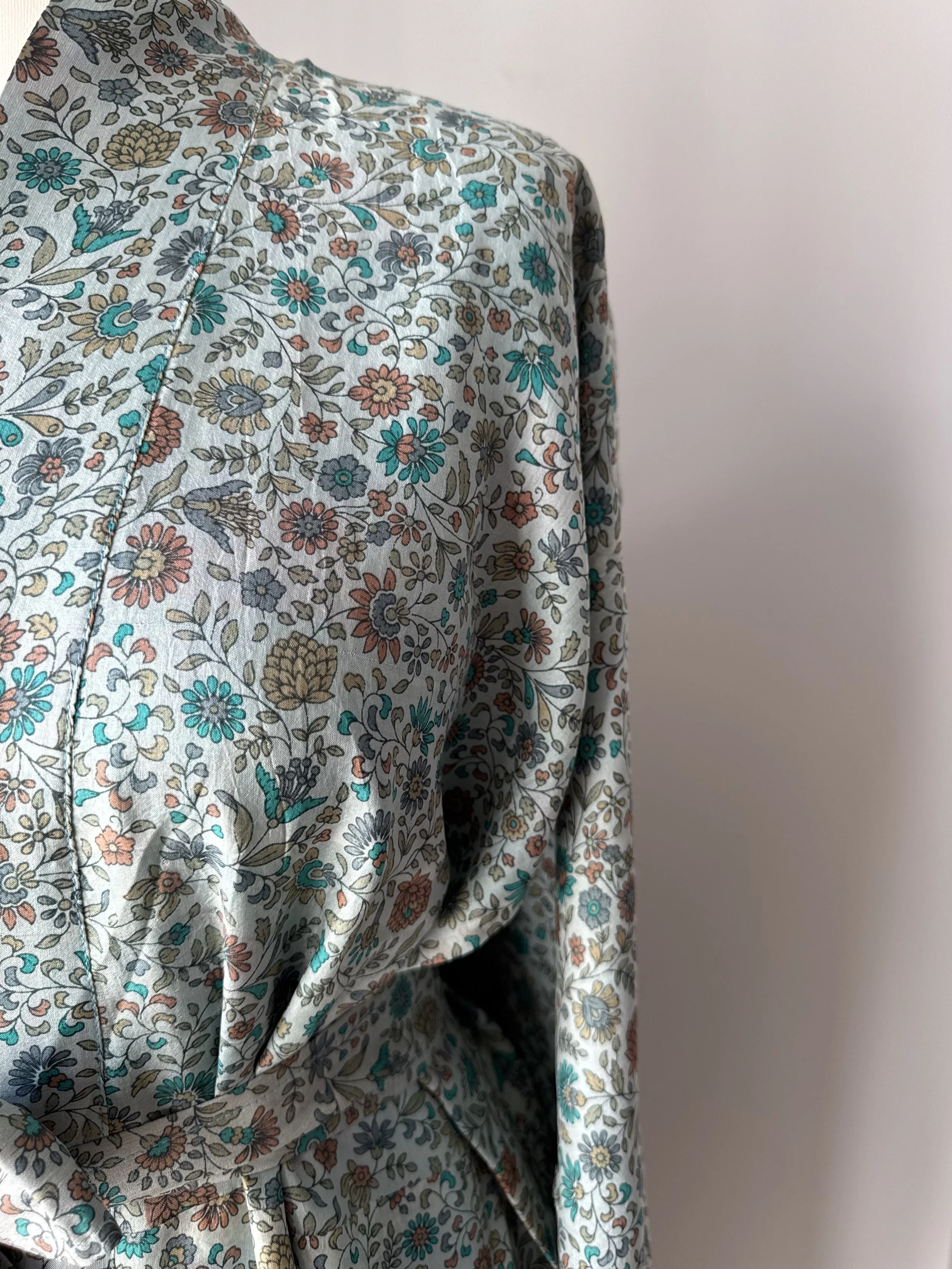 Close up of floral print in blue and cinnamon on recycled sari silk kimono robe