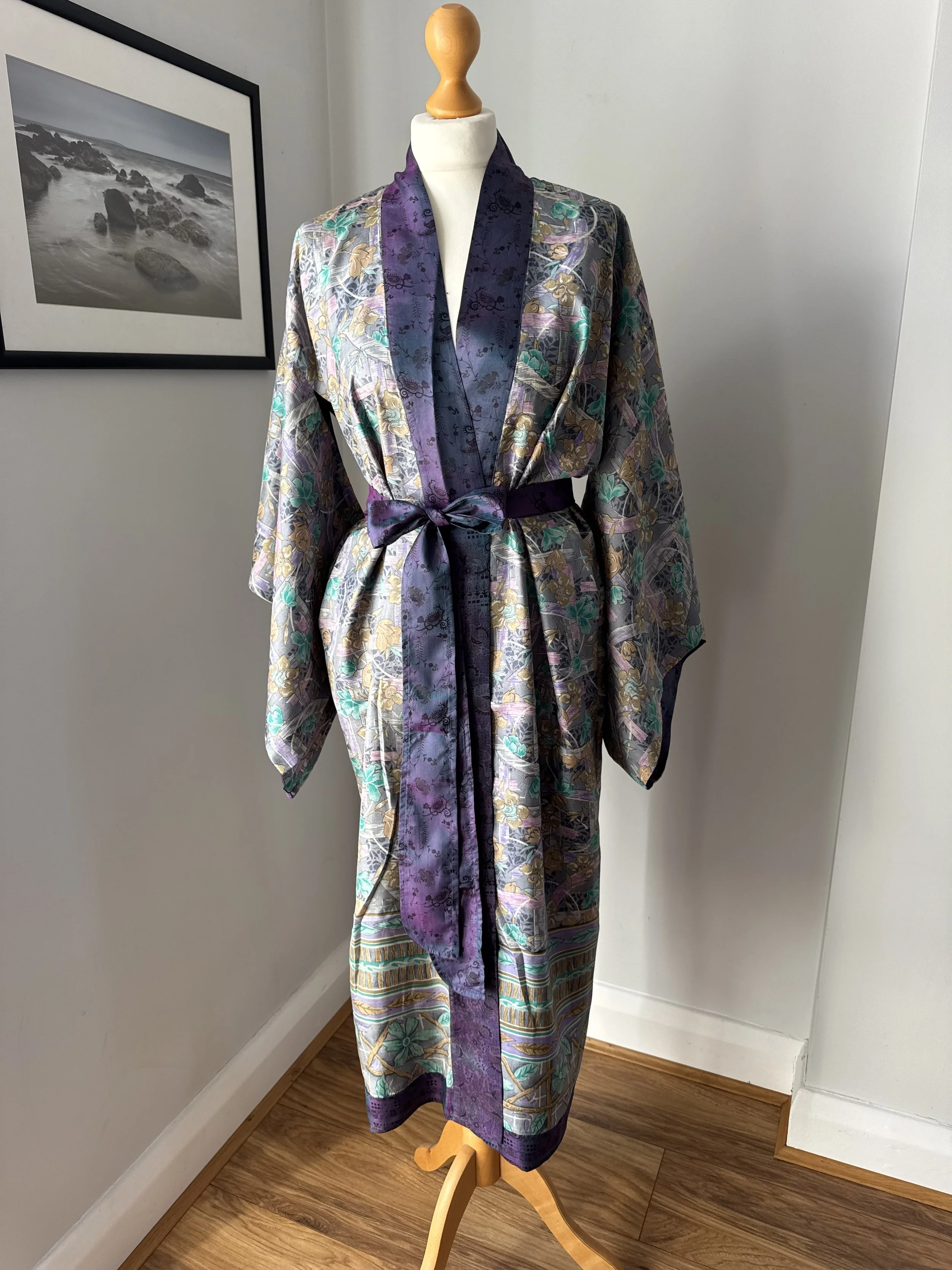 Reversible silk sari kimono robe showing the inside lining in light grey with soft flowers and contrasting purple collar and silk tie belt