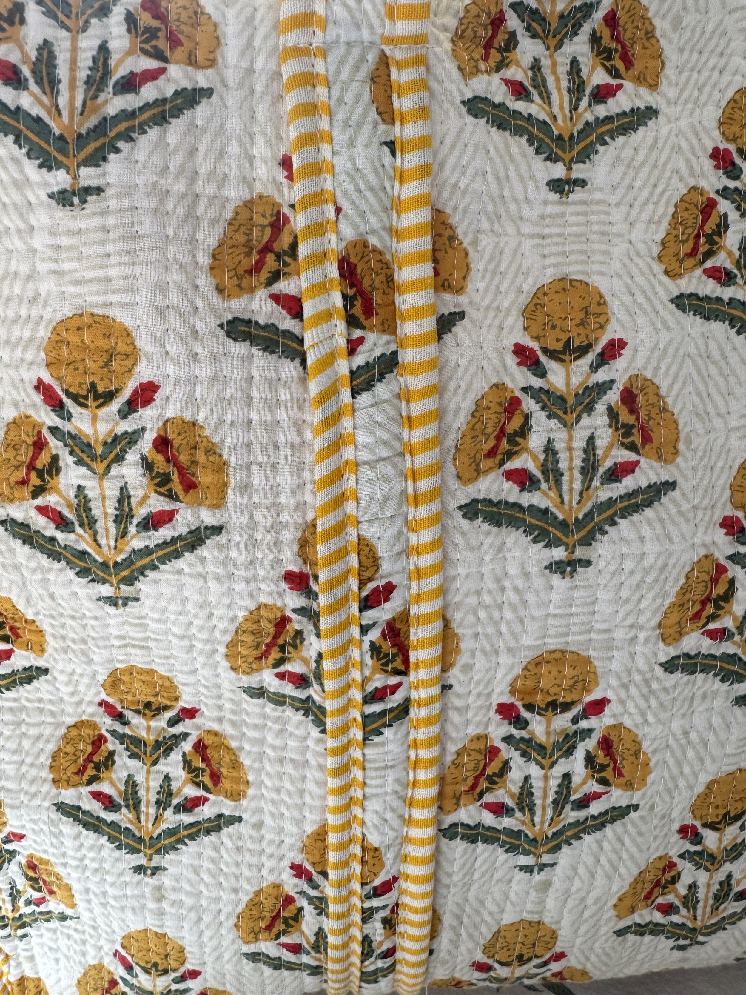Close up of distinctive jaipur flower print in yellow on quilted cotton summer tote bag