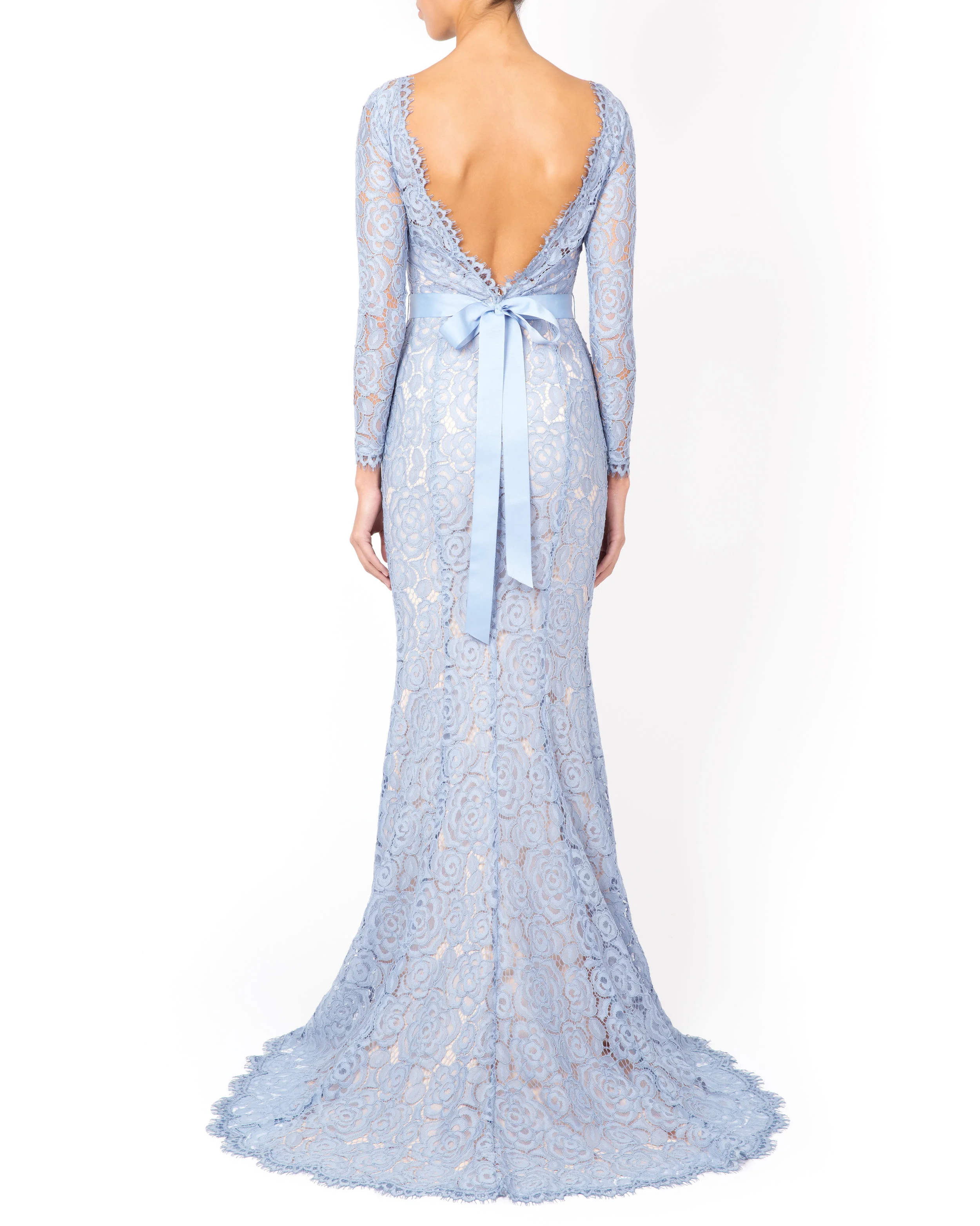 Model wearing the Alara in bluebird facing away to show off the grosgrain ribbon bow and scalloped lace open back.