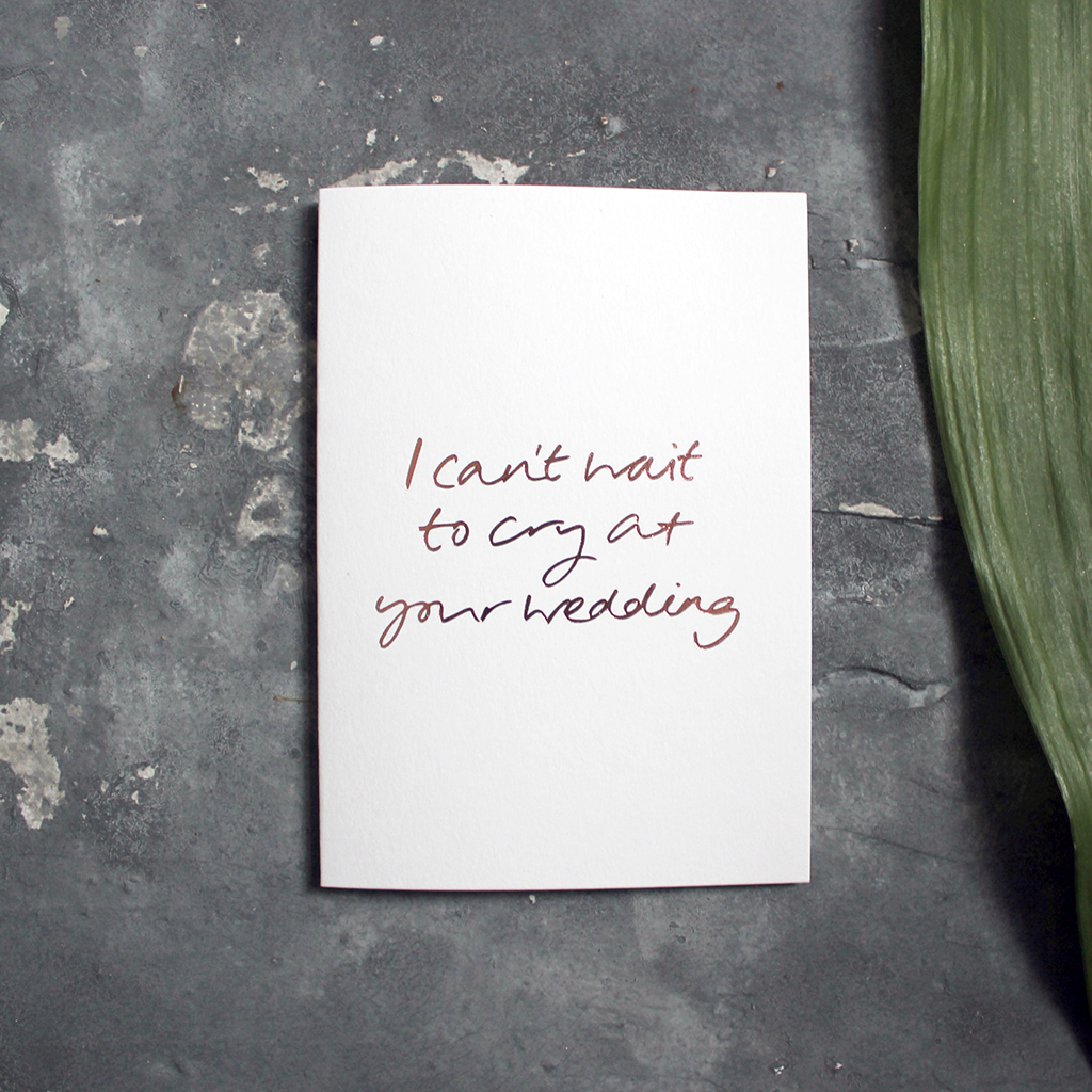 A white wedding guest card that says, I can’t wait to cry at your wedding