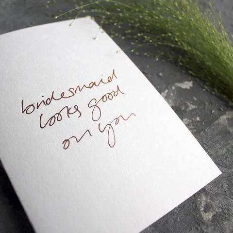 Close up of white bridesmaid looks good on you card.